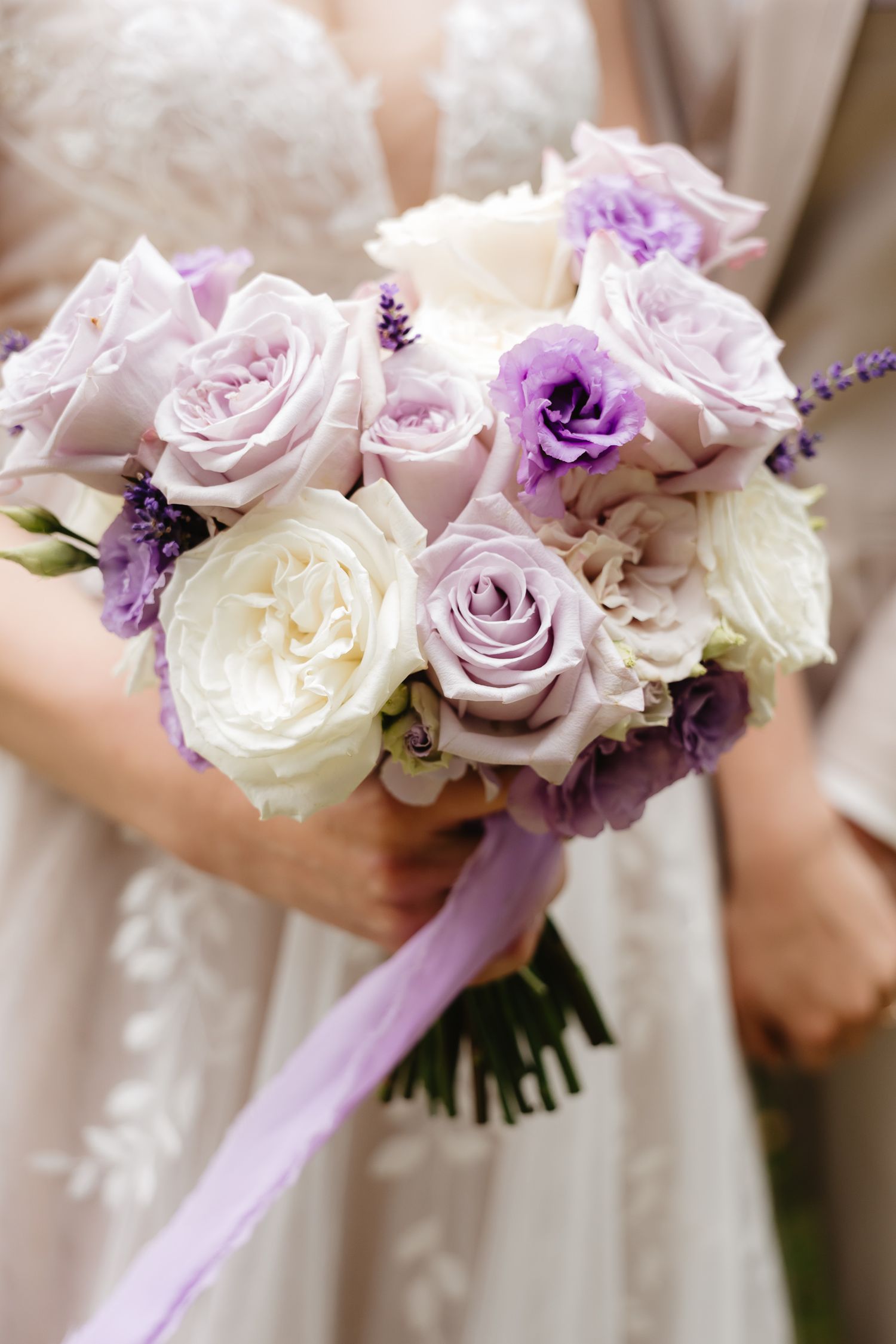 A series of elegant wedding bouquets featuring white and lavender roses with purple accents and ribbons.