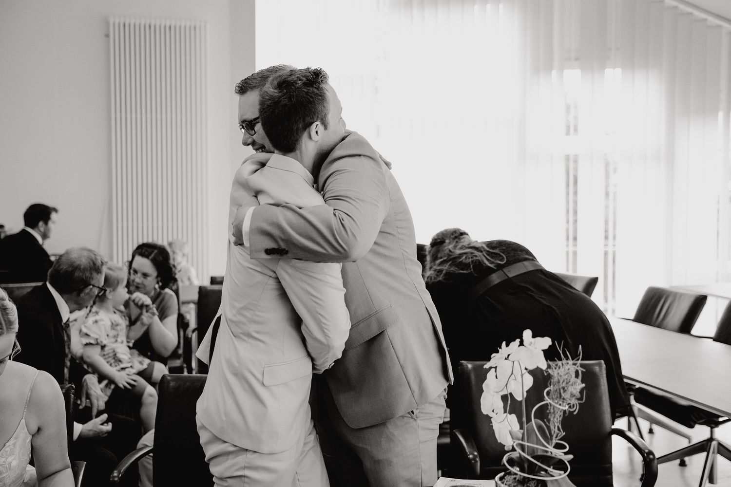 A black and white collage of people dancing and embracing at what appears to be a social gathering or dance event.