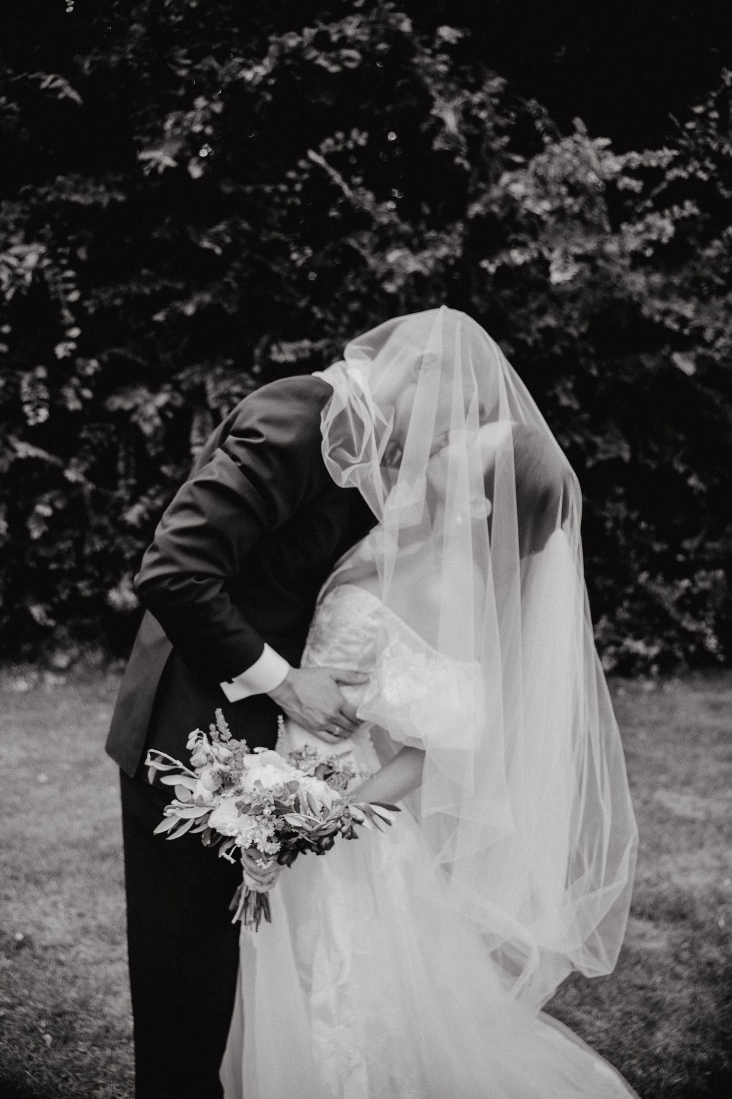 Artistic black and white wedding photography showing romantic dance movements.