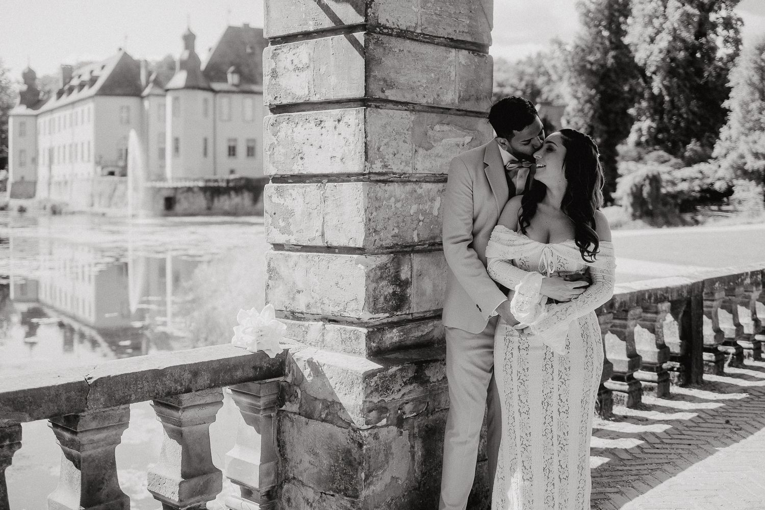 Black and white architectural wedding photos under stone colonnade.