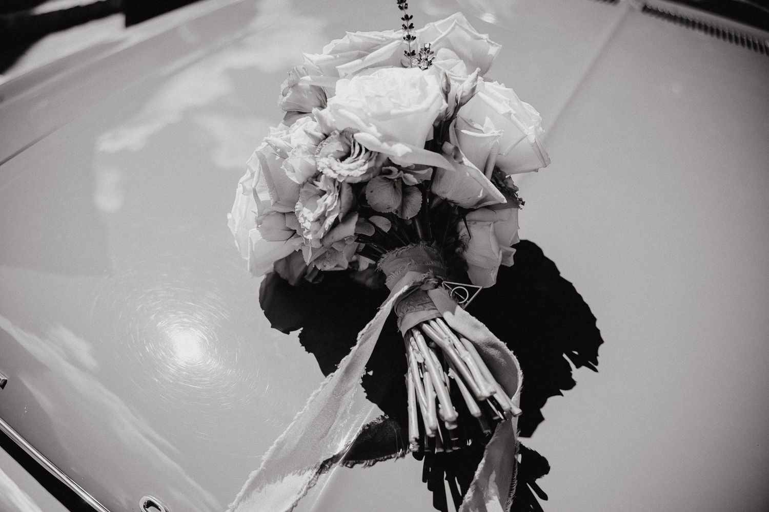 Black and white photograph of a bride and groom dancing together at their wedding reception.