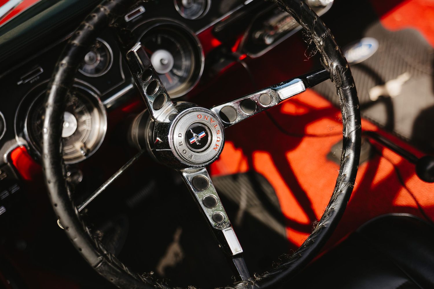 Close-up view of various car steering wheels showing classic vintage automotive interior details.