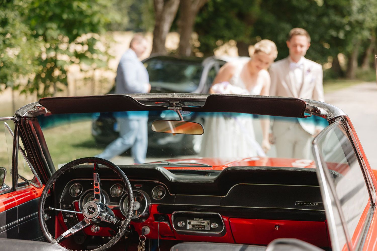 A series of vintage car dashboard and interior shots showing red leather seats and classic instrument panels.