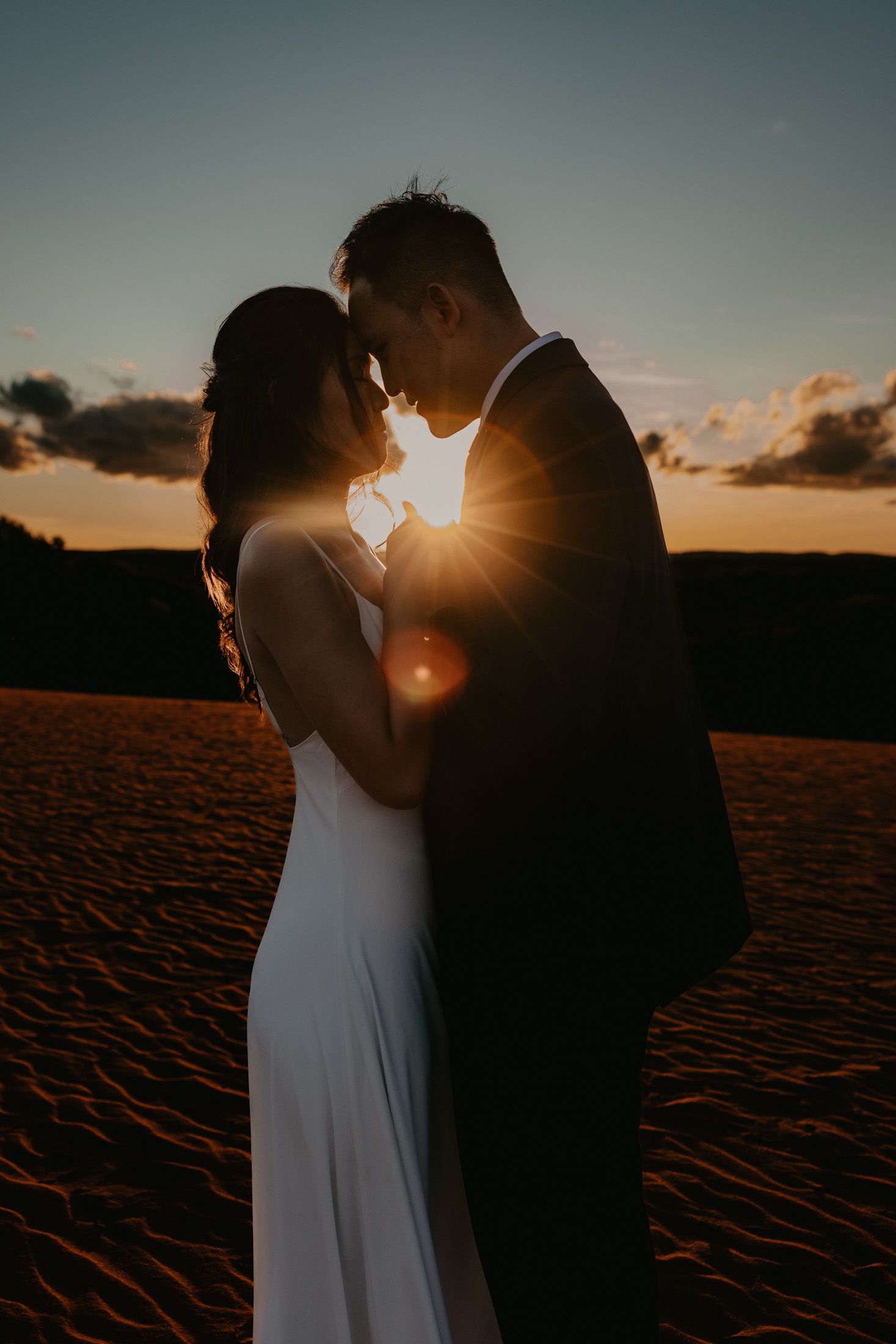 Bride and Groom elopement portrait photographs at sunset on pindan dunes near Exmouth, WA