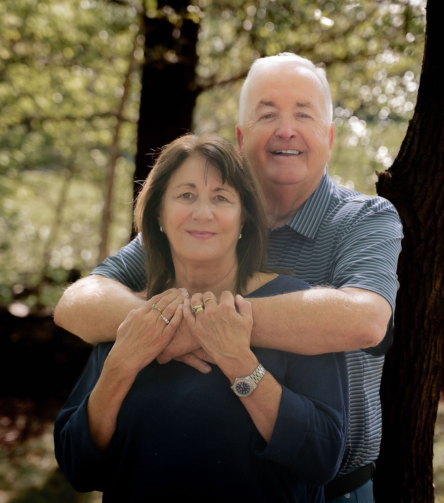 A couple embraces outdoors in a series of candid photos showing playful affection and laughter.