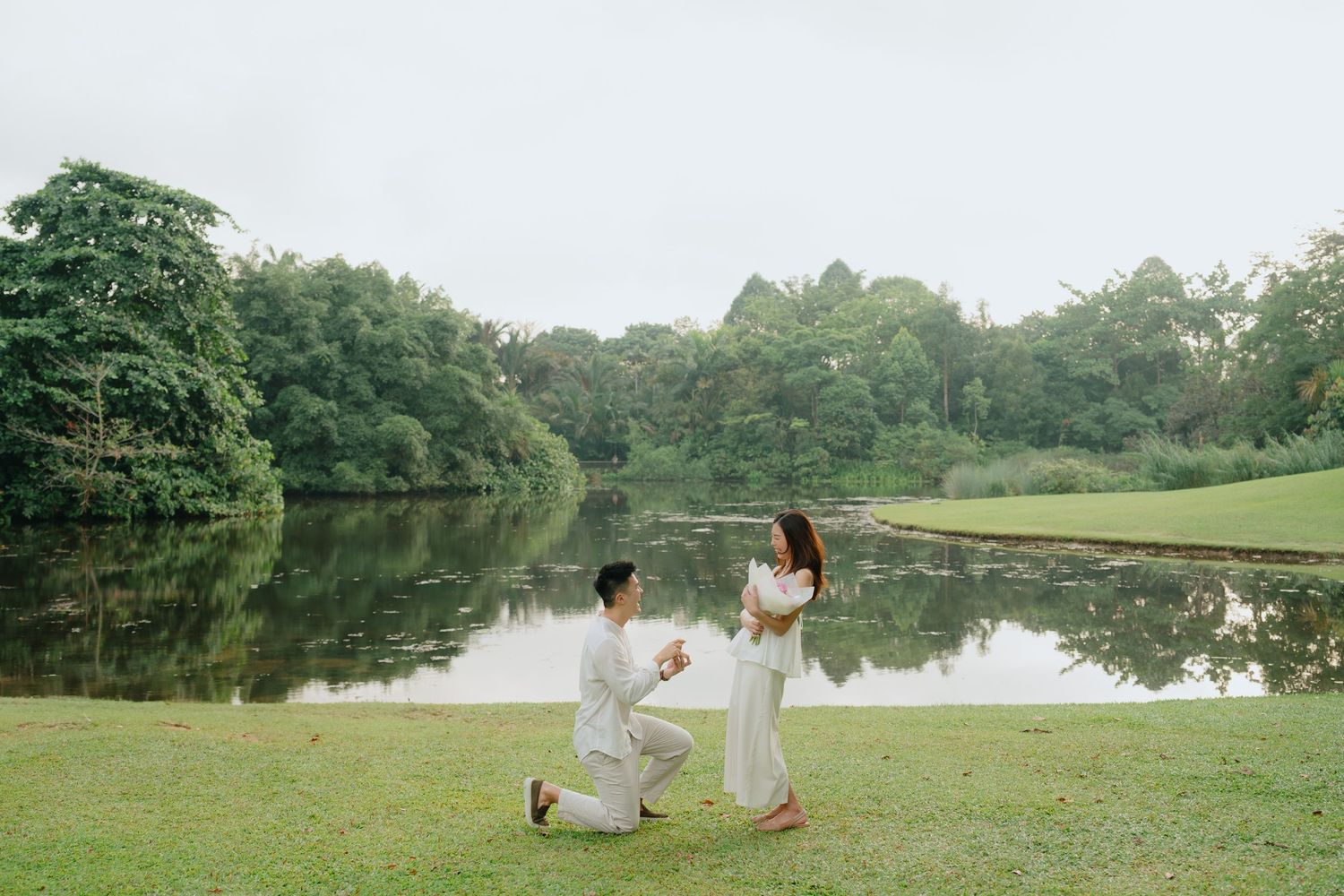 A series of romantic lakeside photos showing figures in white outfits against serene natural landscapes.