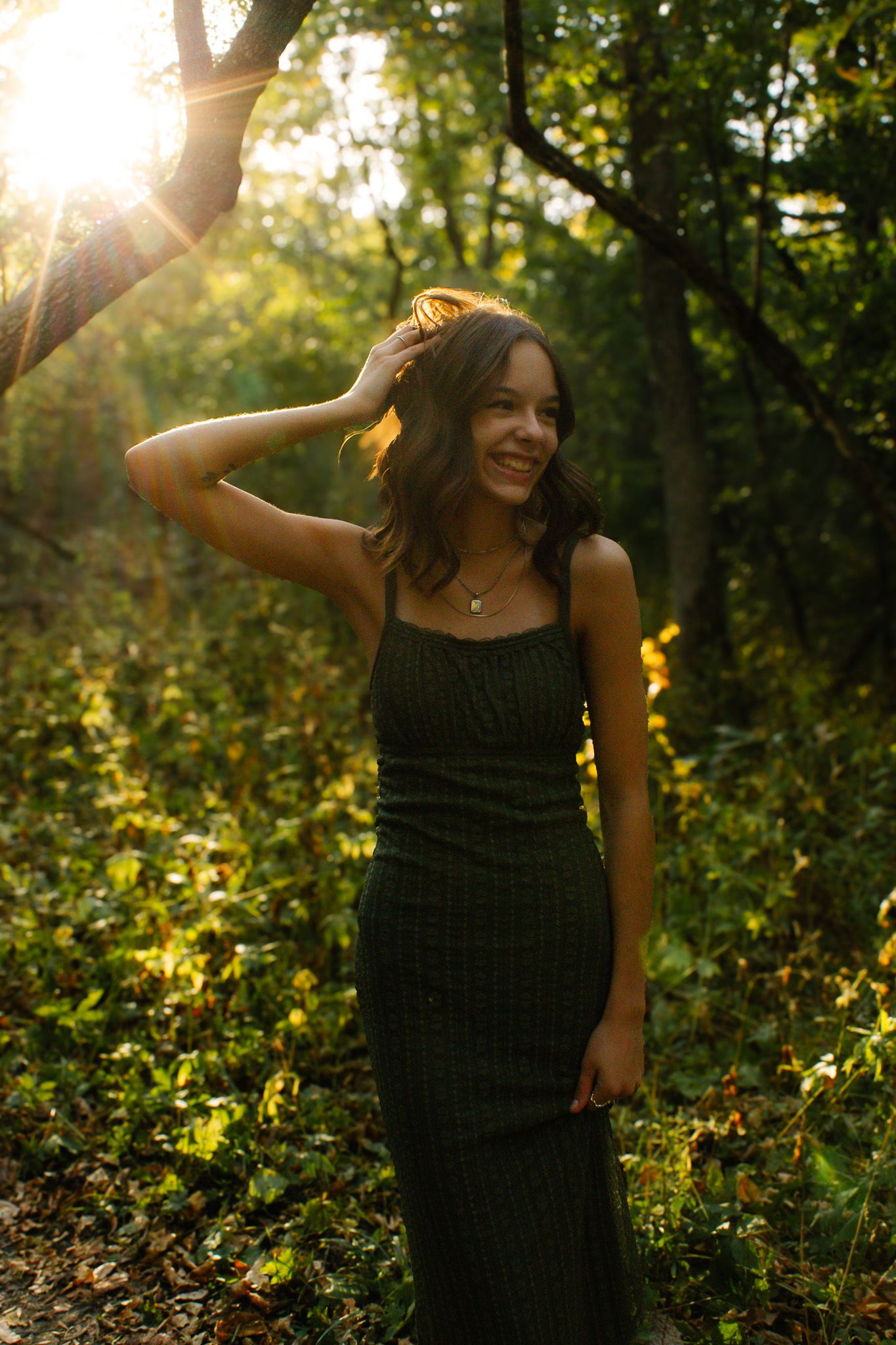 Summer sunset portrait in black tank top with natural golden lighting.