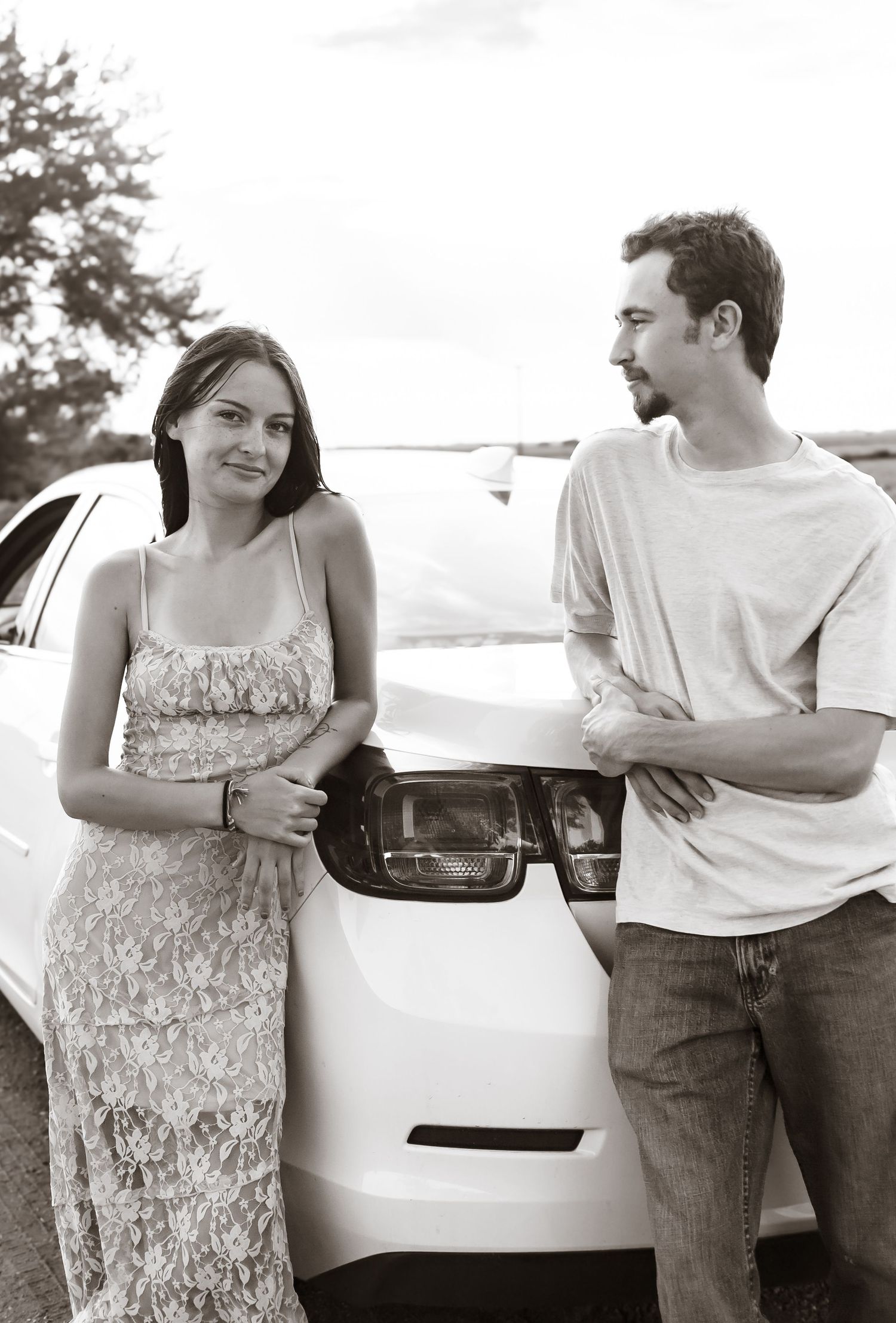 Casual outdoor couple photoshoot series next to a white car.