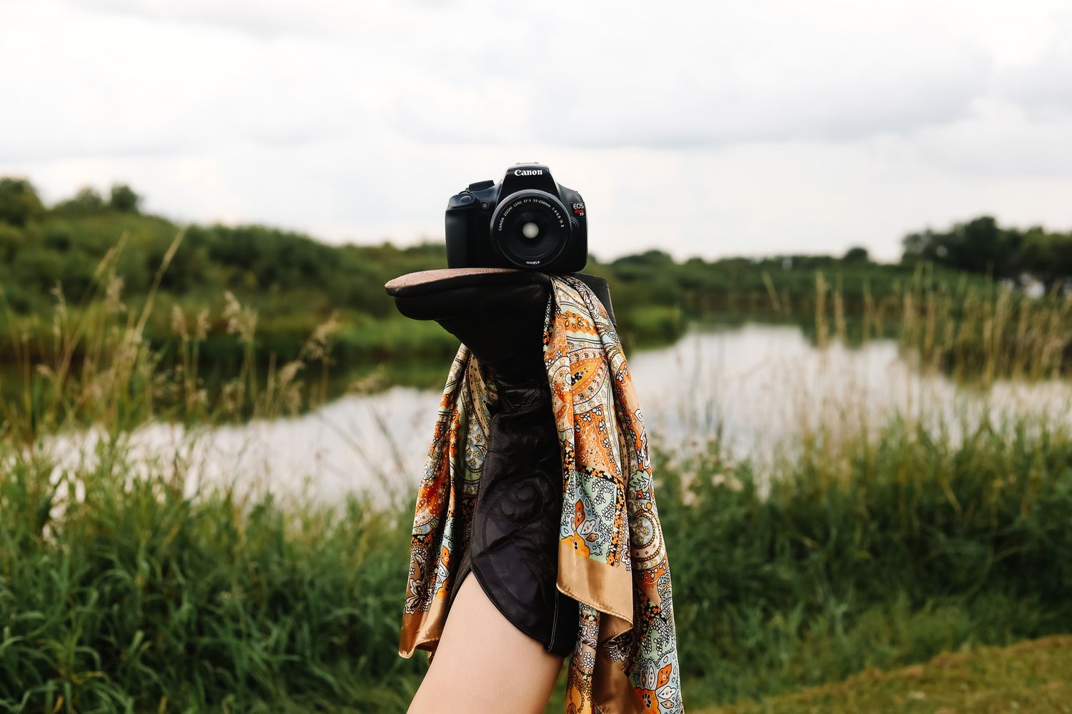 Scenic outdoor photography session by a lake with tall grass and natural lighting.