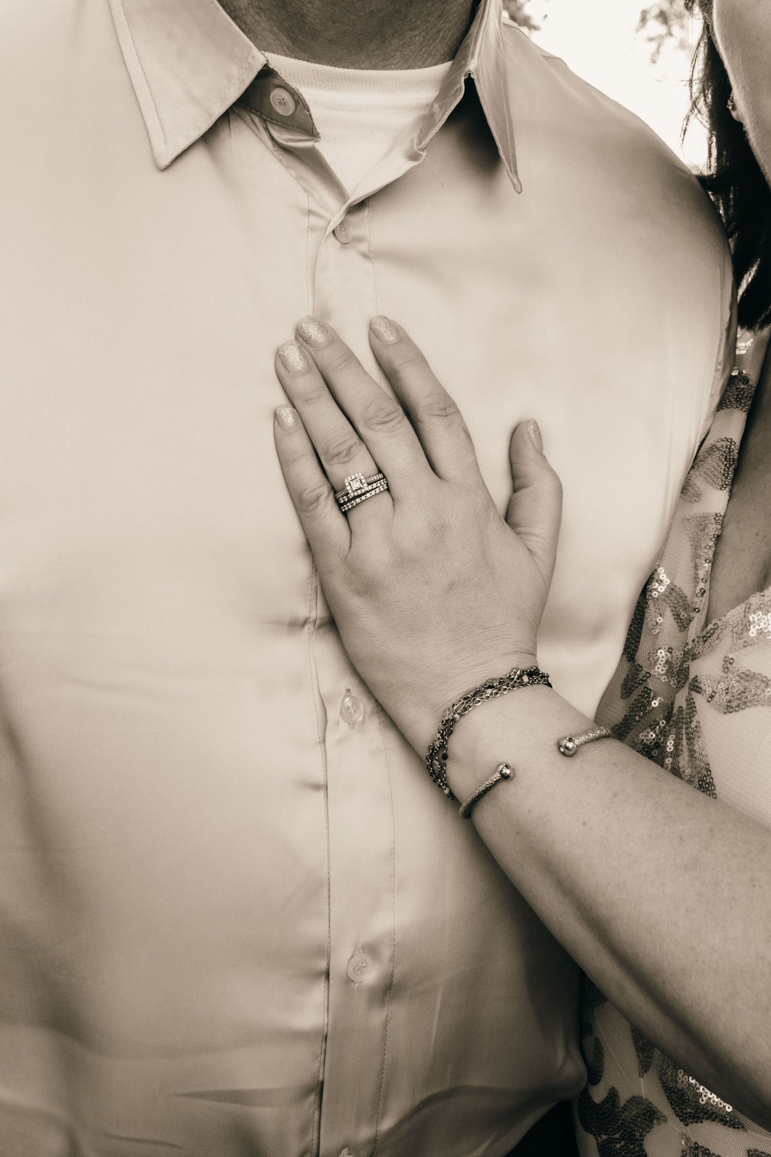 Monochrome close-up shots of intimate hand gestures against light colored clothing.