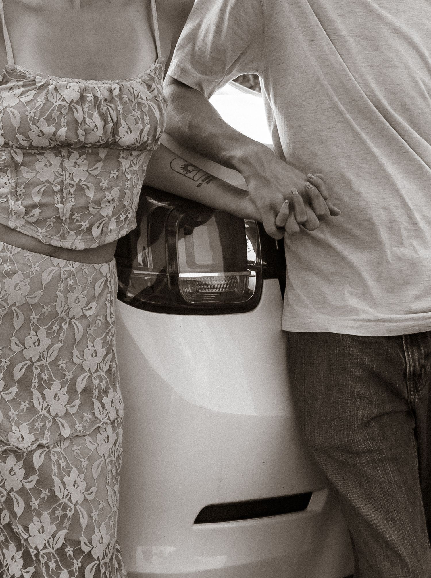 A series of black and white maternity photos showing a pregnant belly in a lace dress.