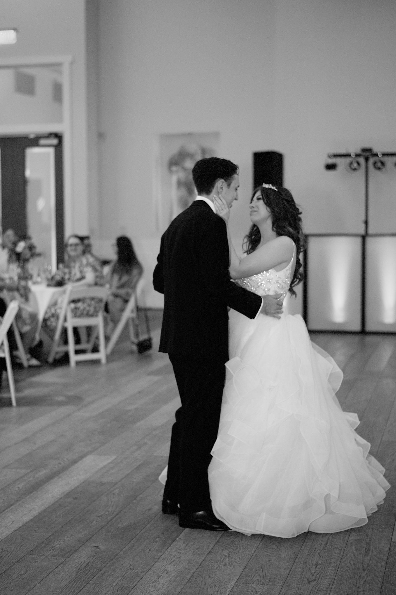Black and white photo sequence of couple dancing in an empty ballroom.