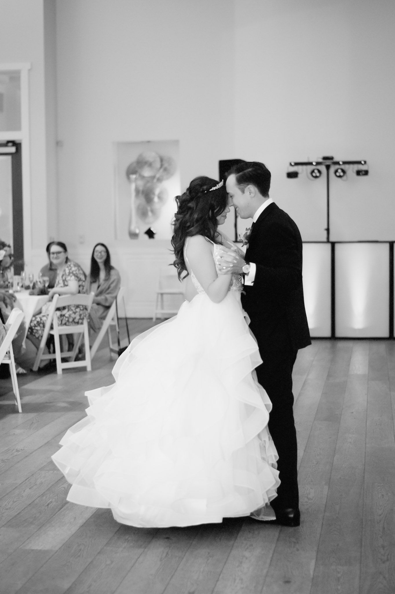 Black and white images capture romantic first dance moments at wedding reception.