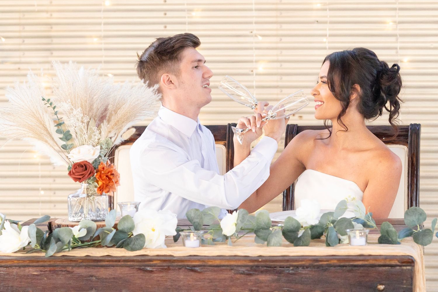 Rustic wedding photography with elegant floral arrangements and natural wood elements.