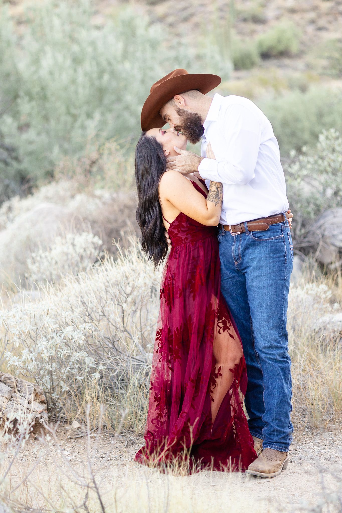 Romantic desert portraits featuring burgundy dress and western style clothing.