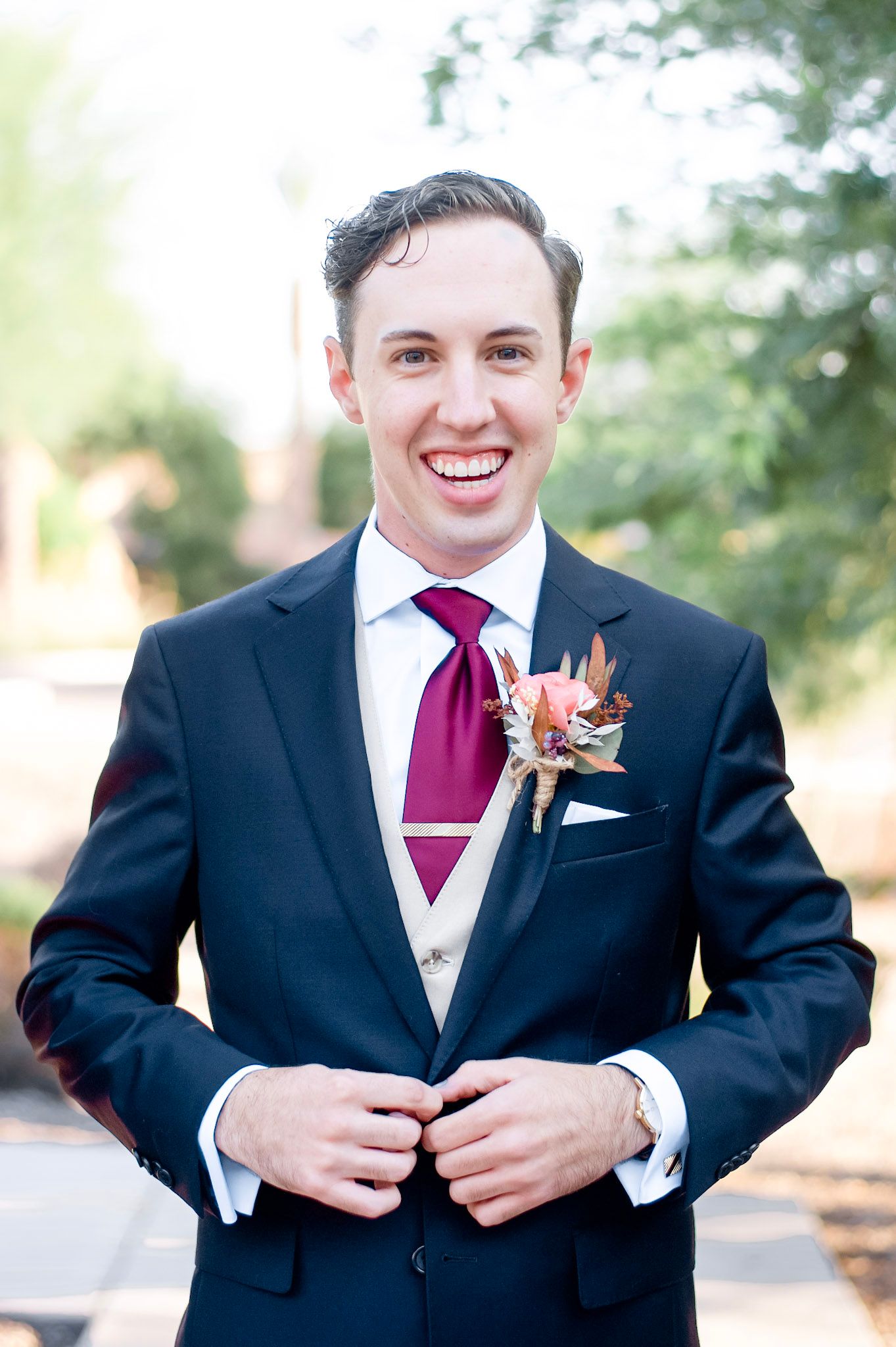 Series of photos showing a groom in a black suit with burgundy tie adjusting his jacket.