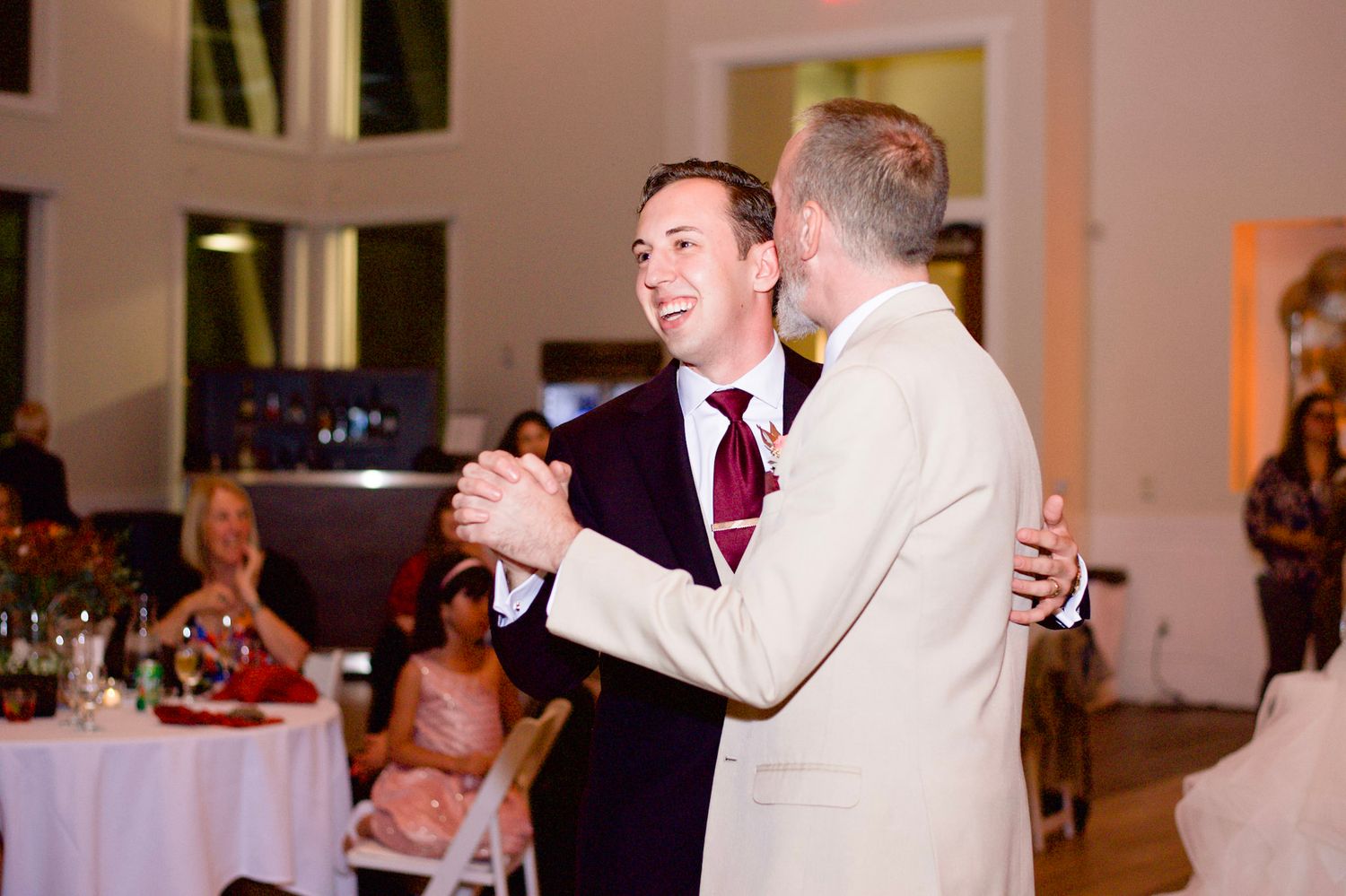 Wedding reception dance floor moments captured in candid celebration shots.