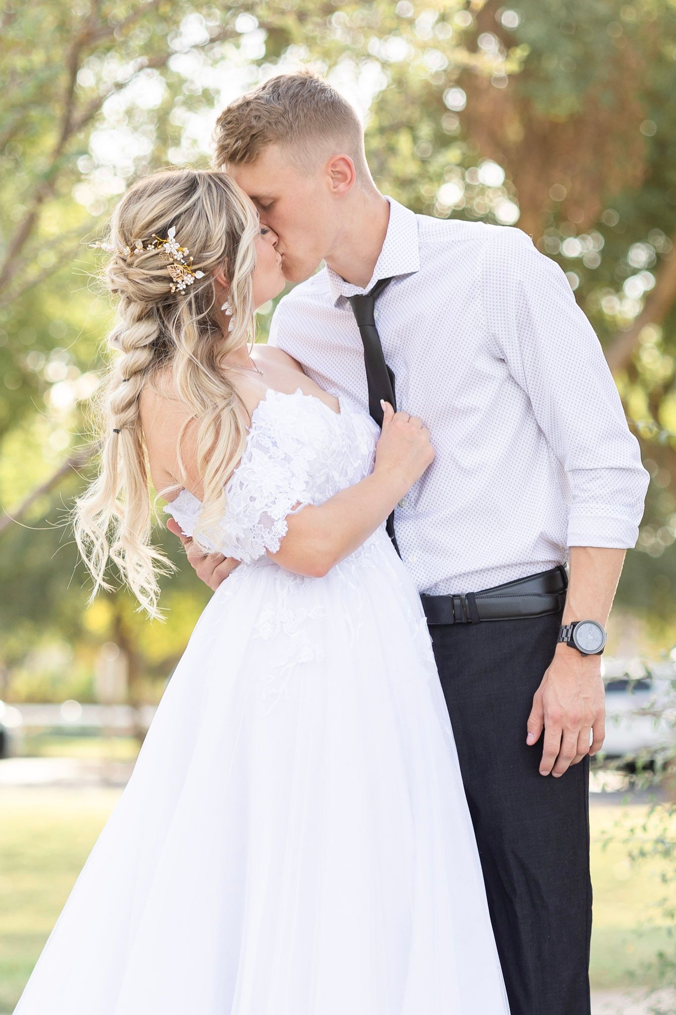 Intimate wedding couple portraits in a sun-dappled garden setting.