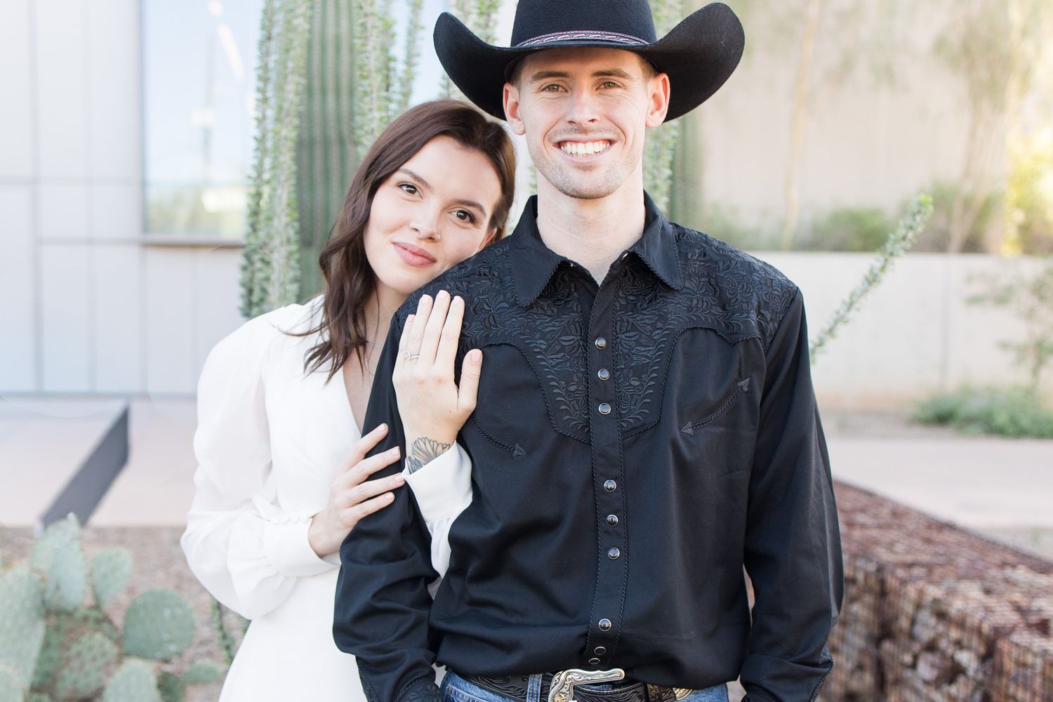 Western-themed wedding portraits with couple in casual black attire in Tucson, Arizona.
