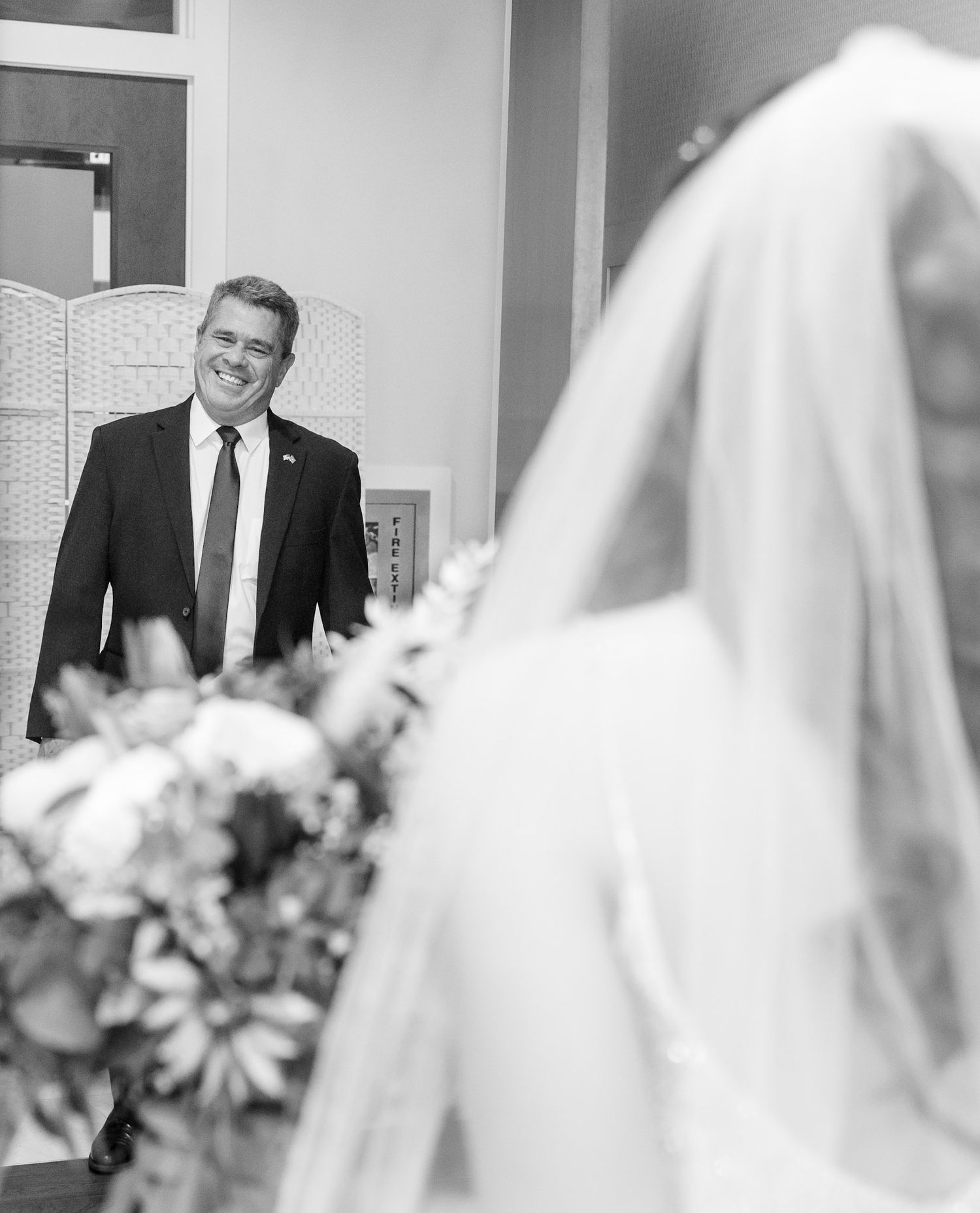 Intimate black and white wedding ceremony moments captured through veil.