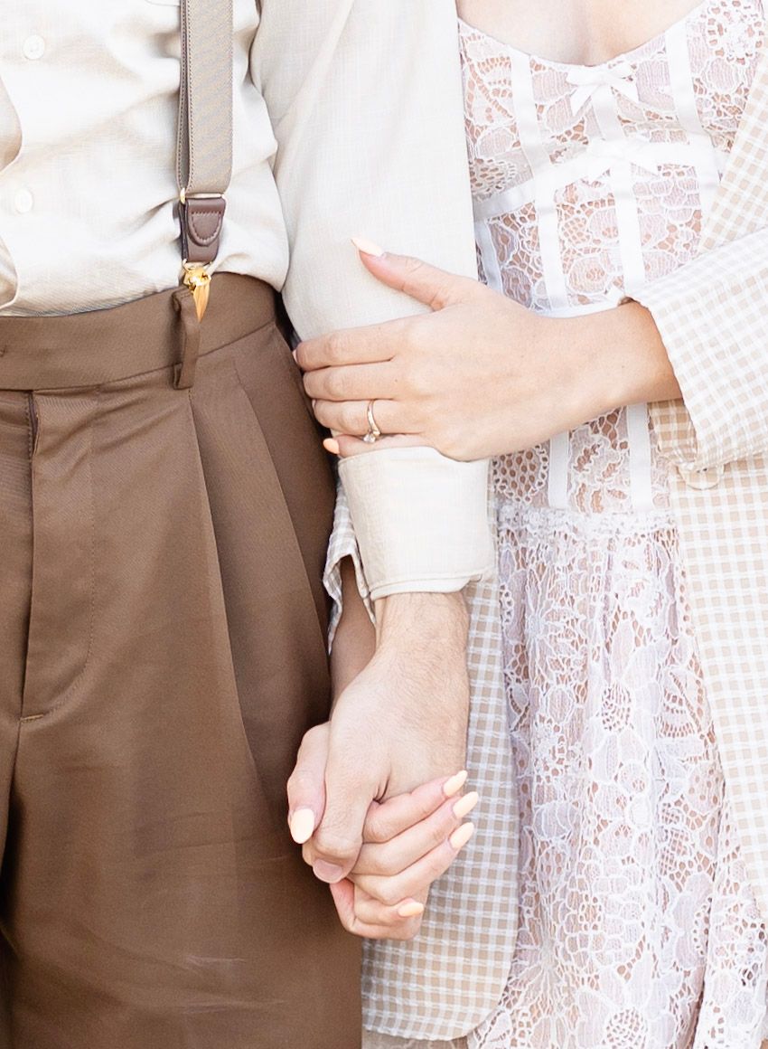 Close-up details of vintage-inspired romantic attire in cream and brown tones.