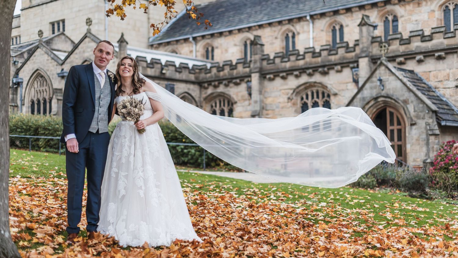 Panoramic view of a wedding ceremony outside a grand gothic cathedral with autumn leaves. Ephemera.