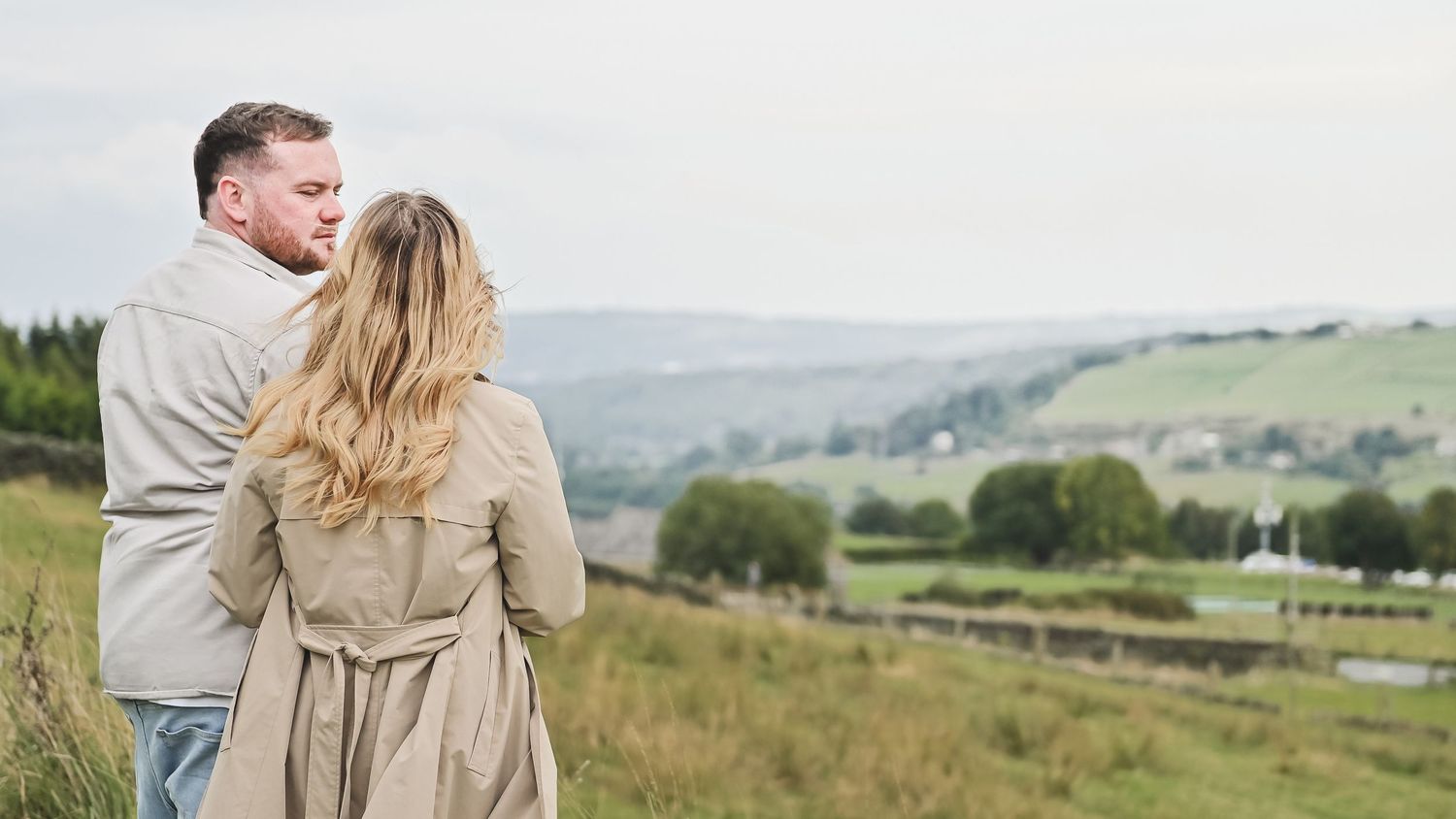 Couple in casual wear overlooking scenic countryside landscape. Ephemera.