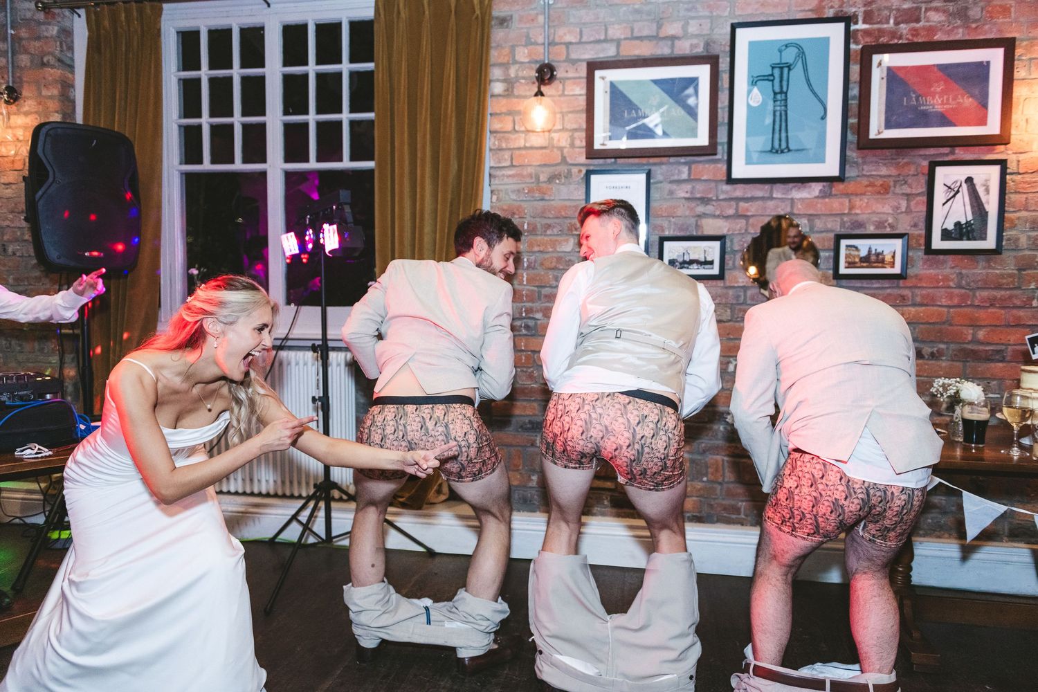 Sequence of dance moves being performed in a rustic bar setting with brick walls and framed artwork. Ephemera.