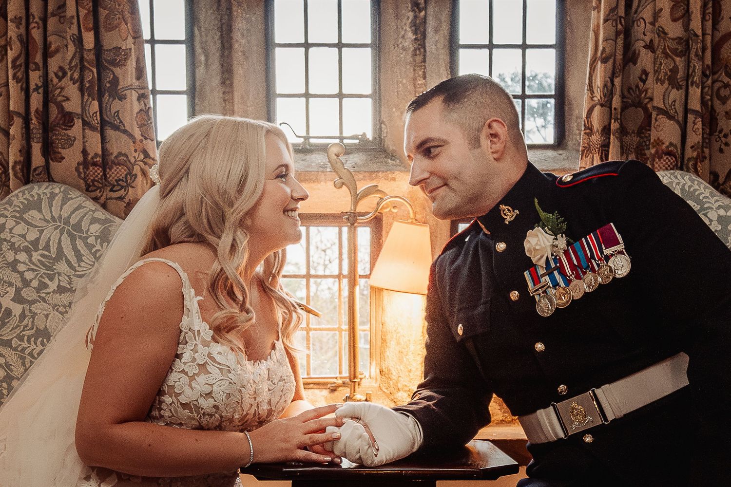 Intimate wedding portrait by window with warm sunlight streaming through. Ephemera.