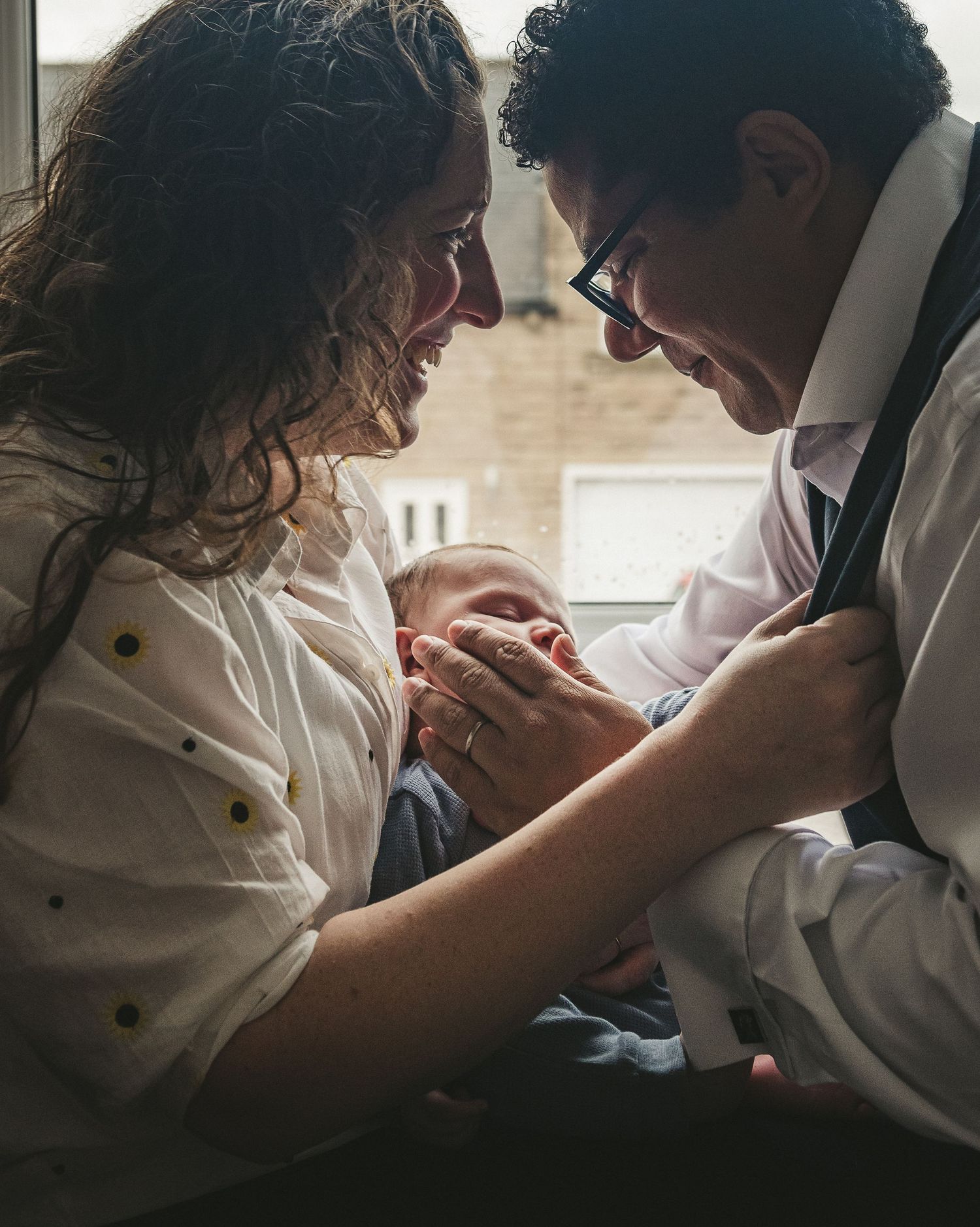 An intimate family moment shared while holding a small baby. Ephemera.