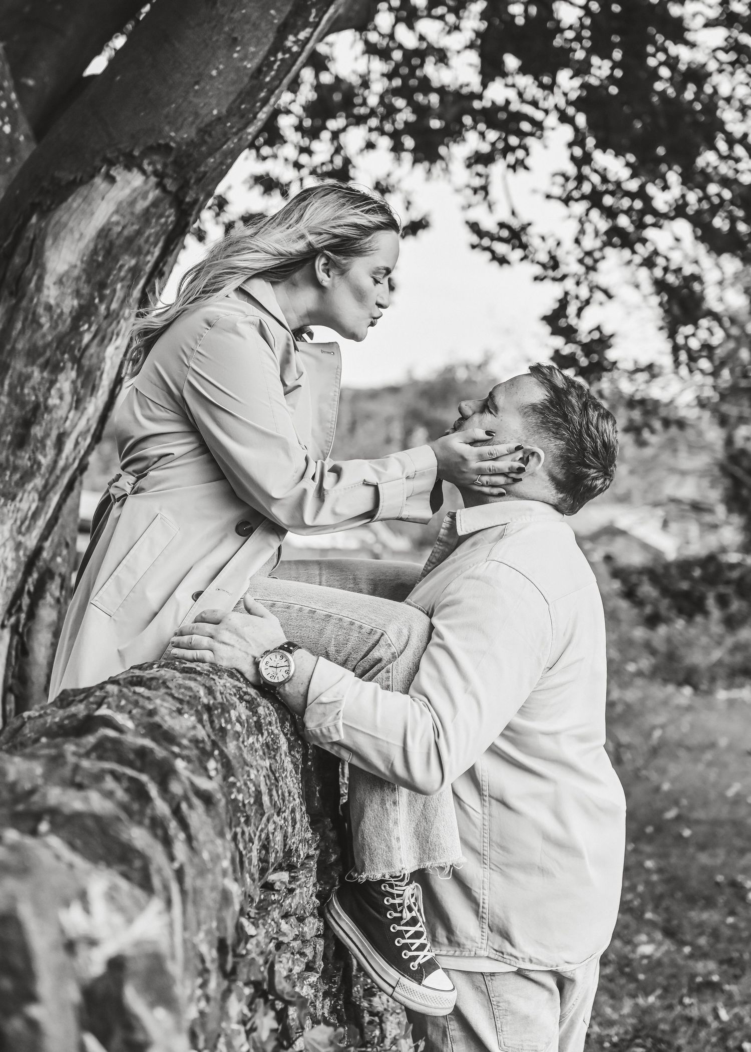 Romantic black and white portrait of couple sharing intimate moment against tree. Ephemera.