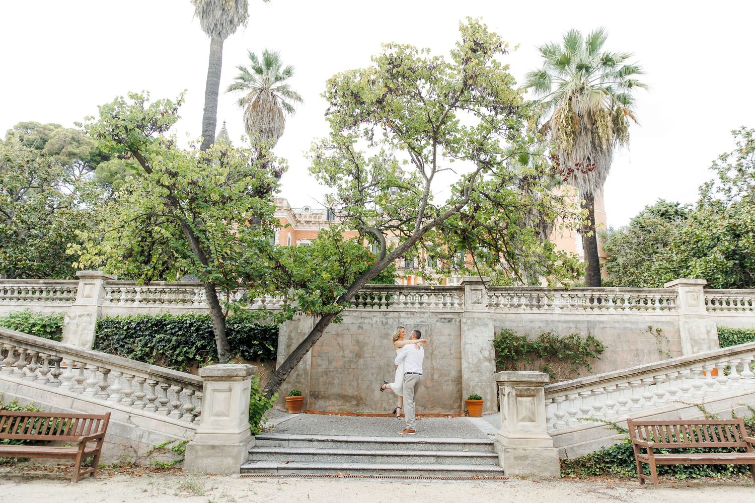 A couple dances in the gardens of Barcelona.