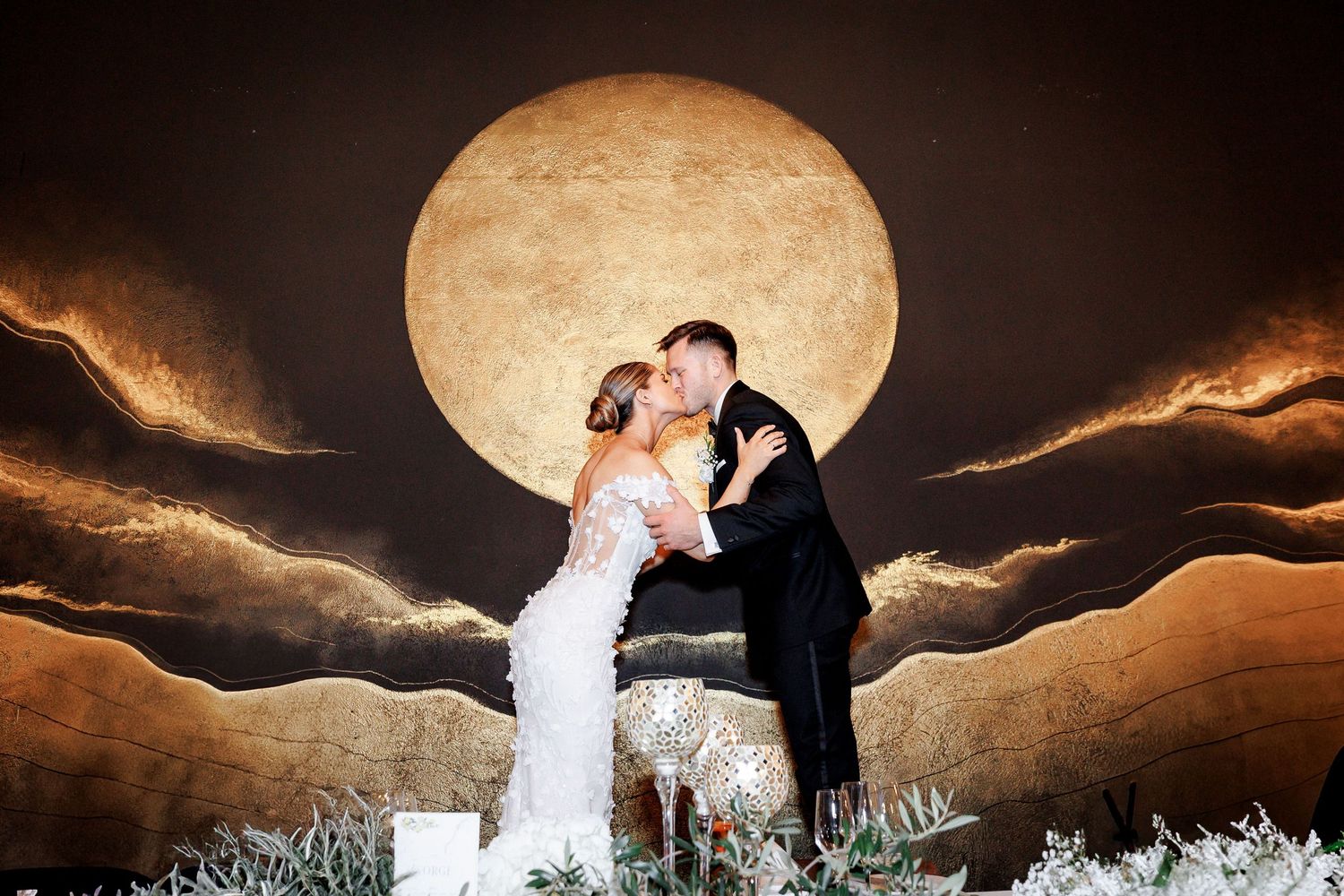 The passionate kiss the groom shares with the bride.