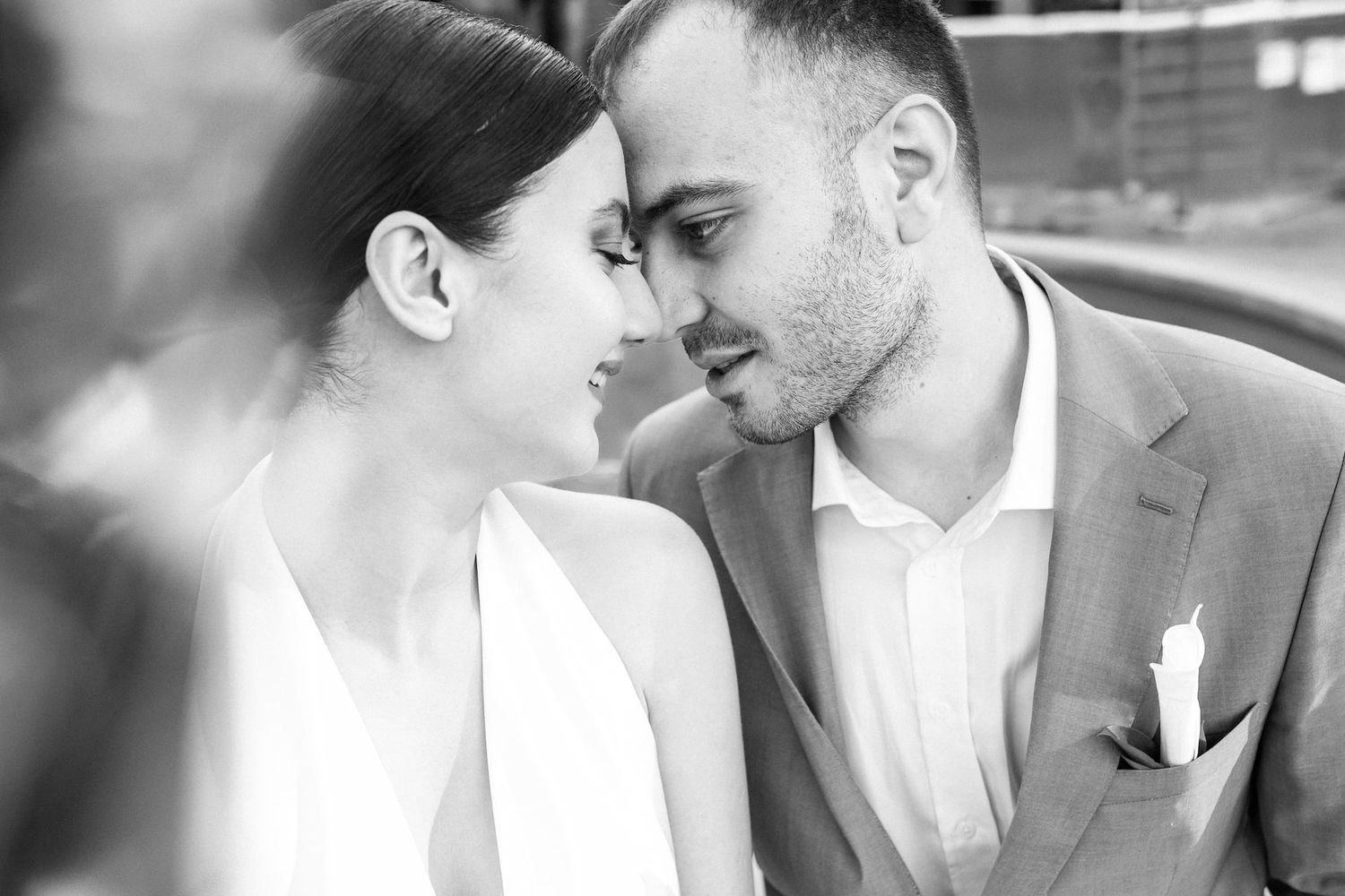 A romantic black and white photo series showing tender moments between a couple on their wedding day.