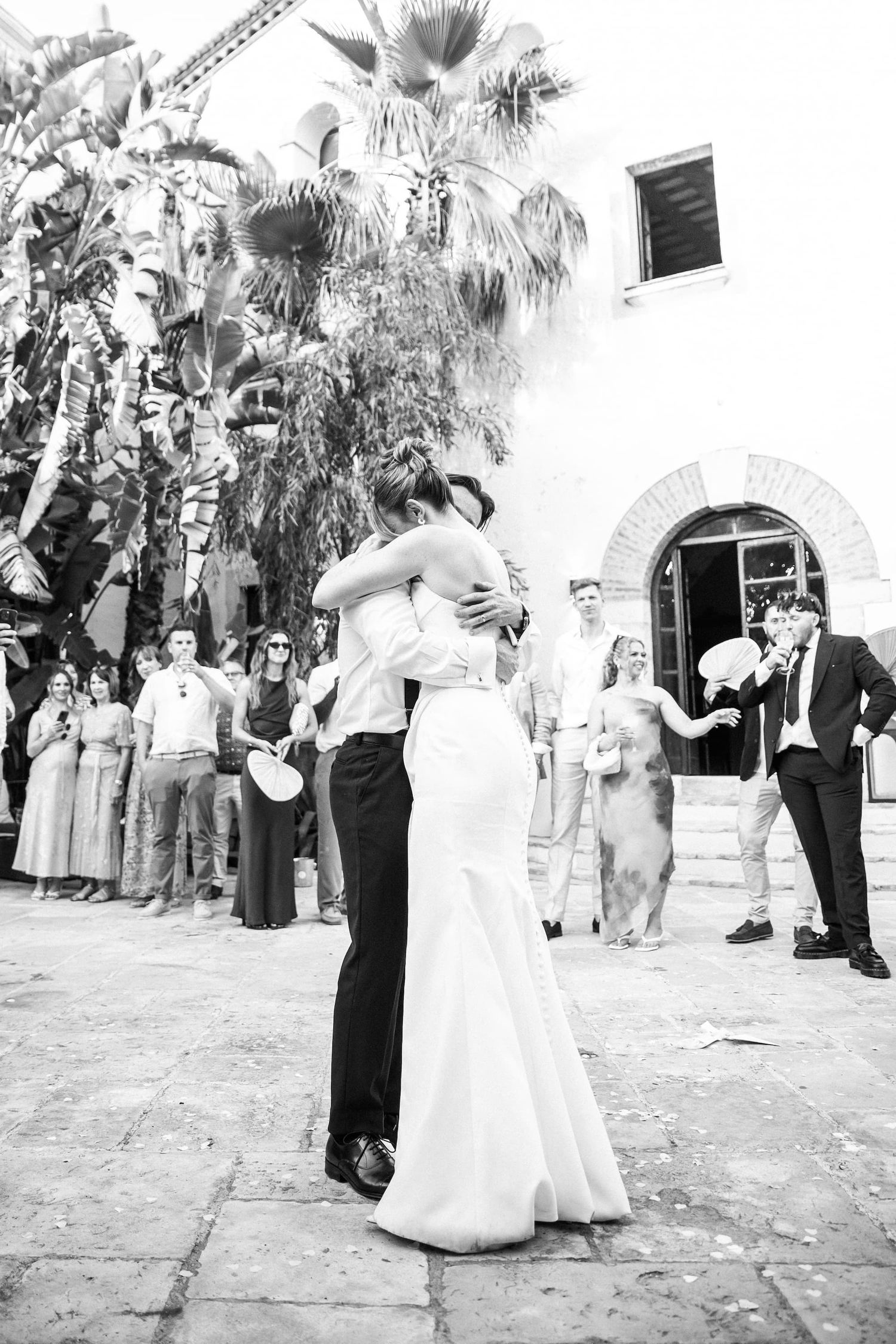 Black and white photo of the bride and groom sharing the first dance outdoors of Masia Victoria wedding venue