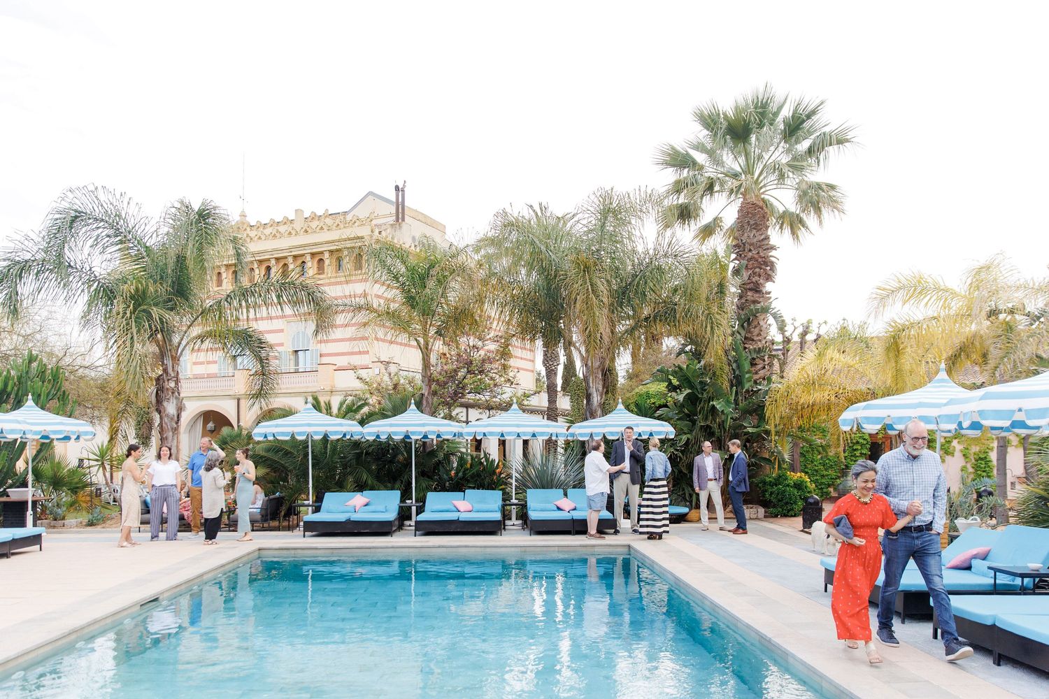 A group of guests is enjoying the rehearsal party at Gran Villa Rosa.