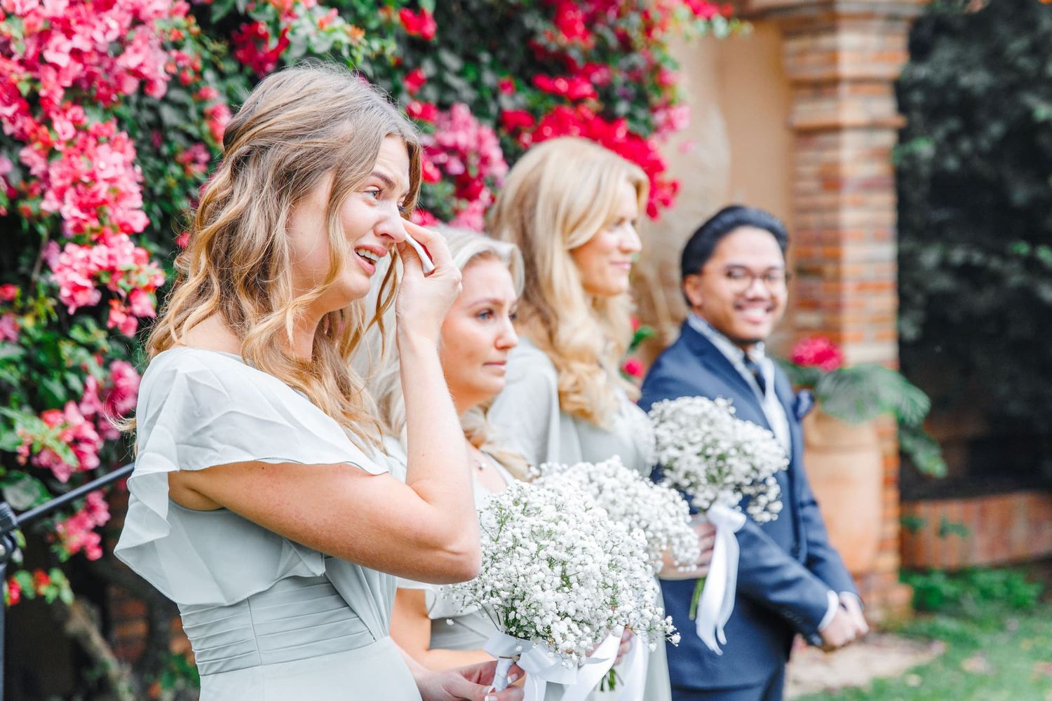 Emotional bridesmaids crying at outdoor wedding ceremony in Barcelona