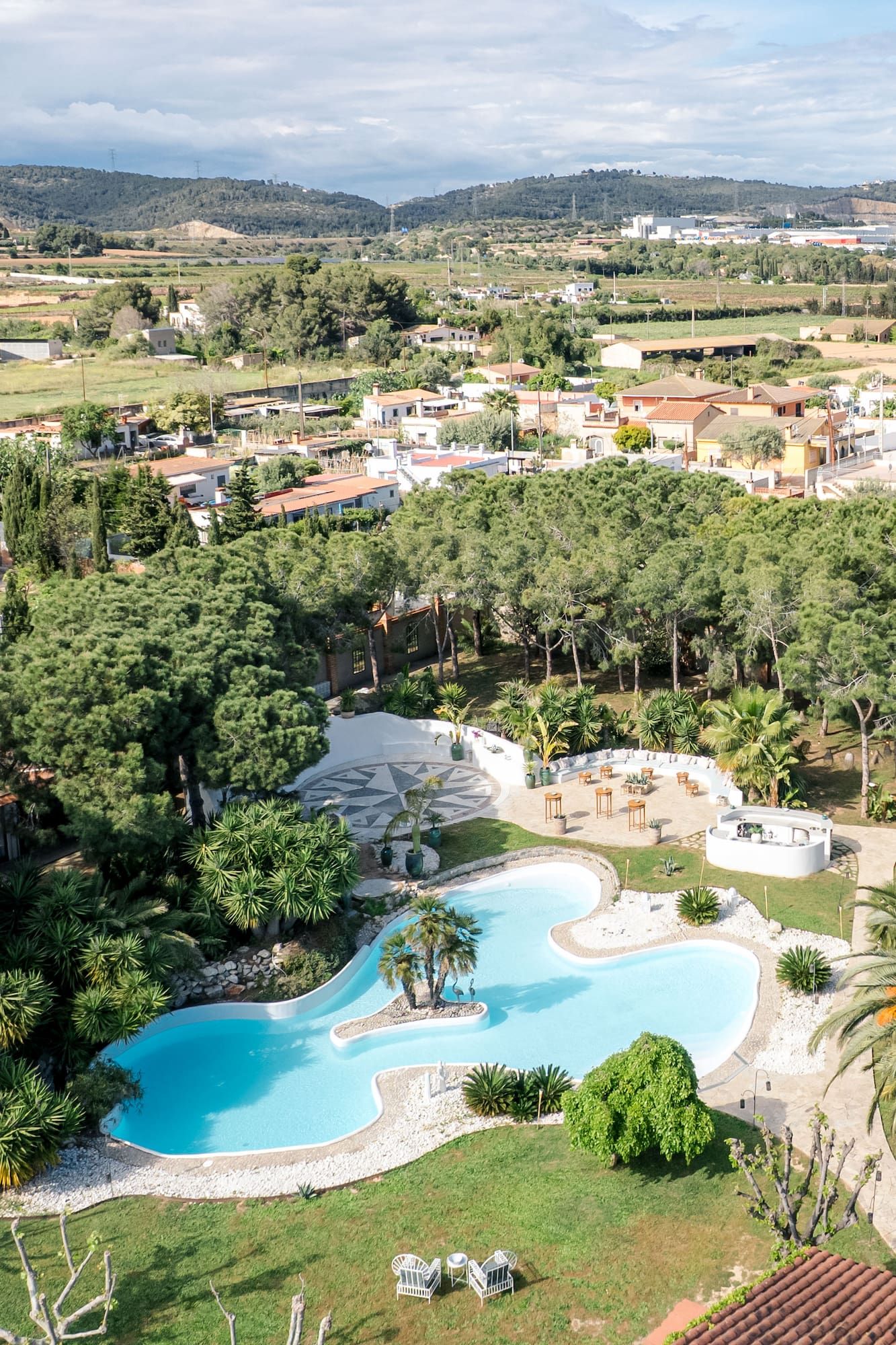 Drone shot of the wedding venue next to Barcelona with the mountains in the background.