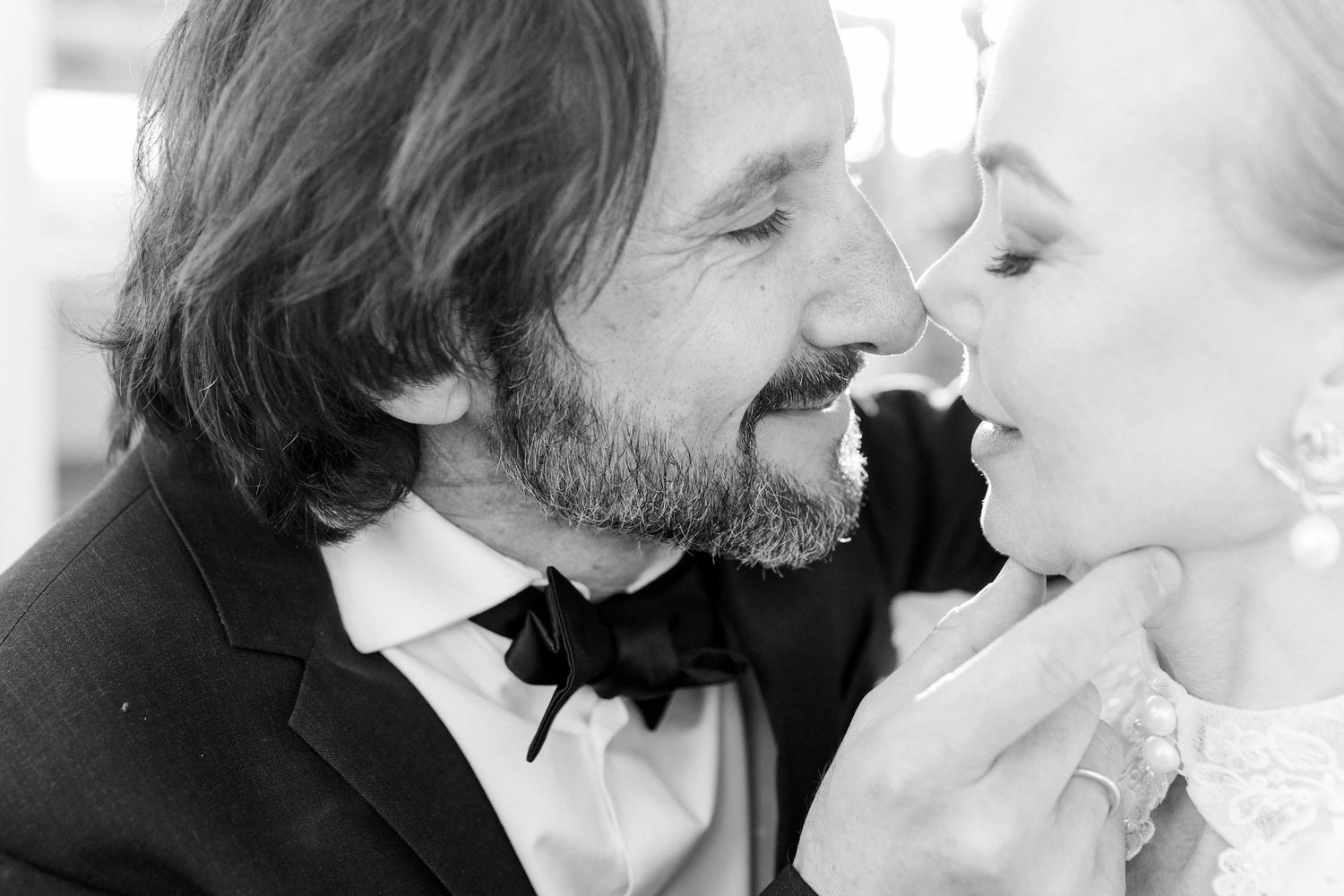Groom gives a gentle kiss to the bride during the wedding ceremony in Barcelona