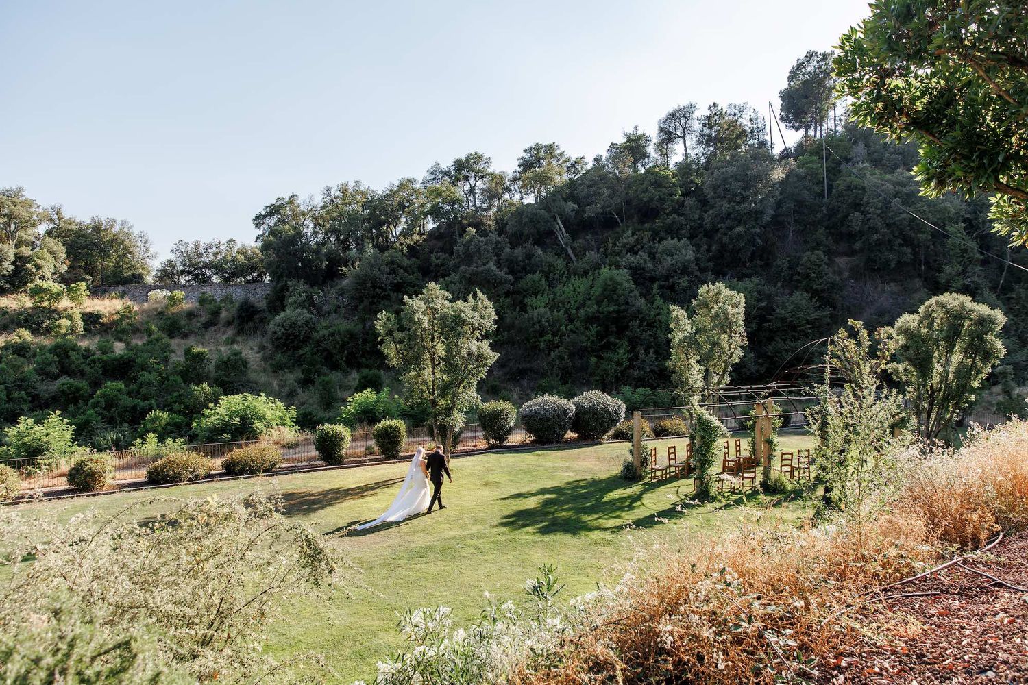 A romantic couple portrait with a scenic view at golden hour at their wedding in Mas Huix, Barcelona