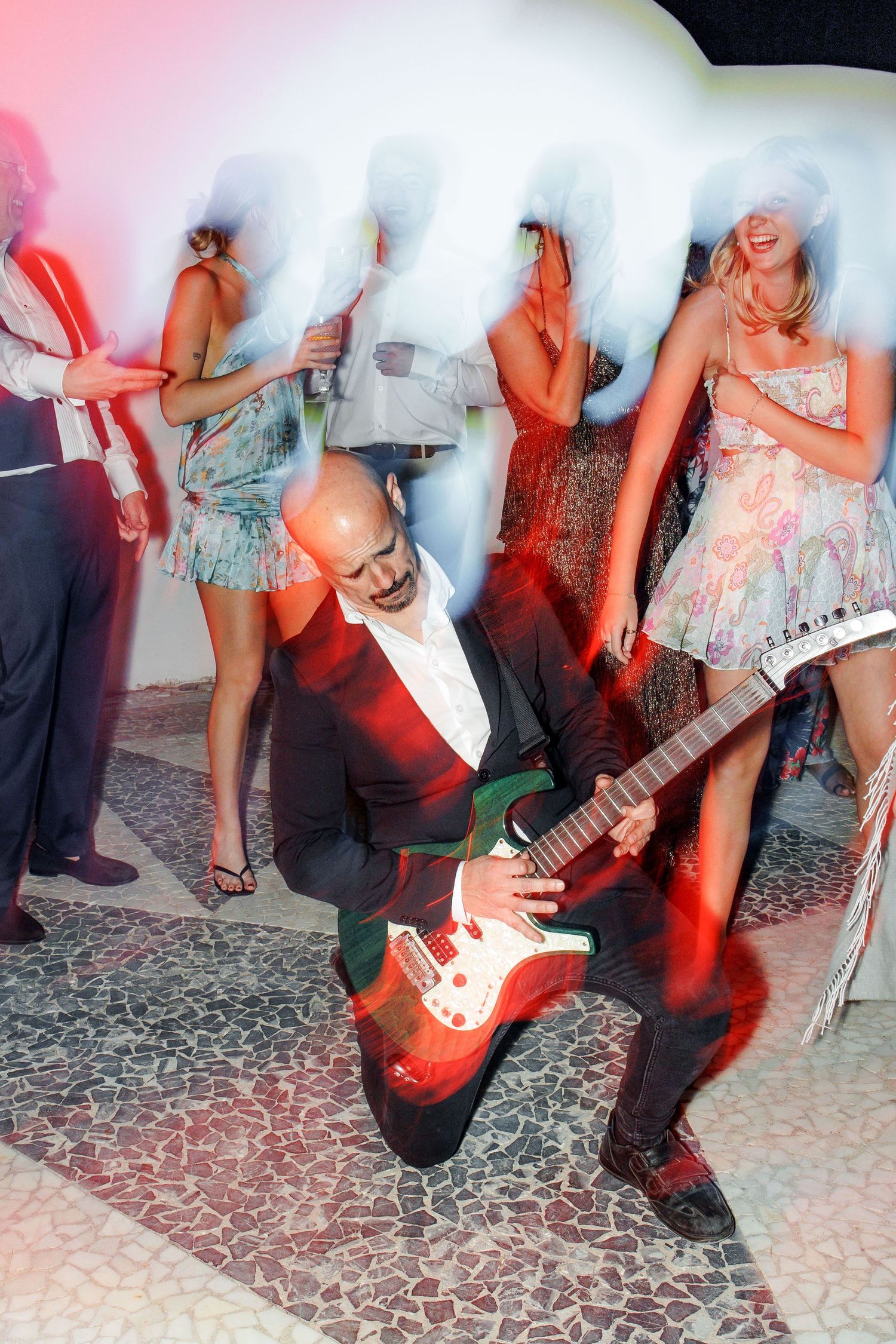 A man with a guitar plays music during the dance party at Gran Villa Rosa.
