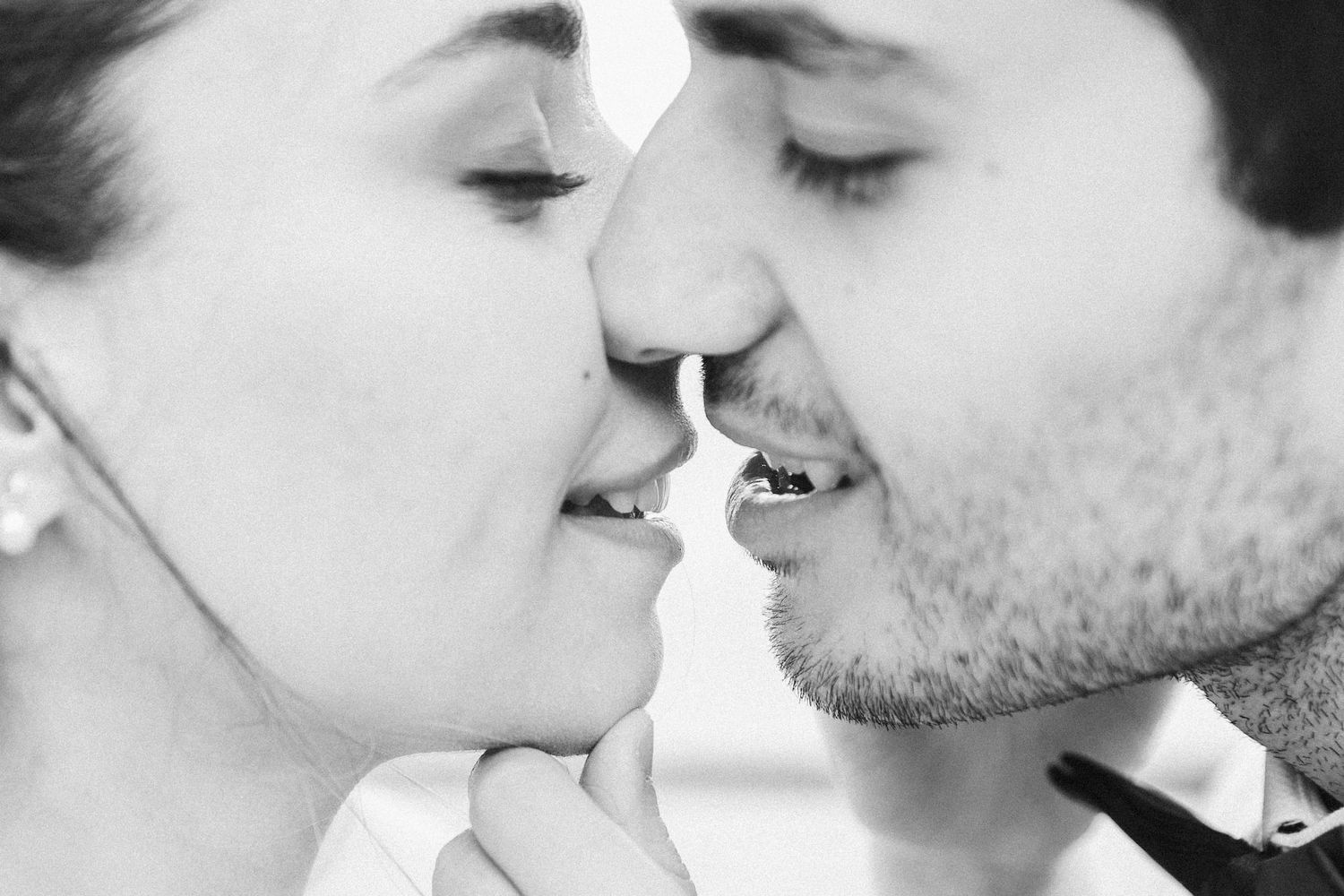 Black and white close-up photos showing tender romantic moments between a couple.