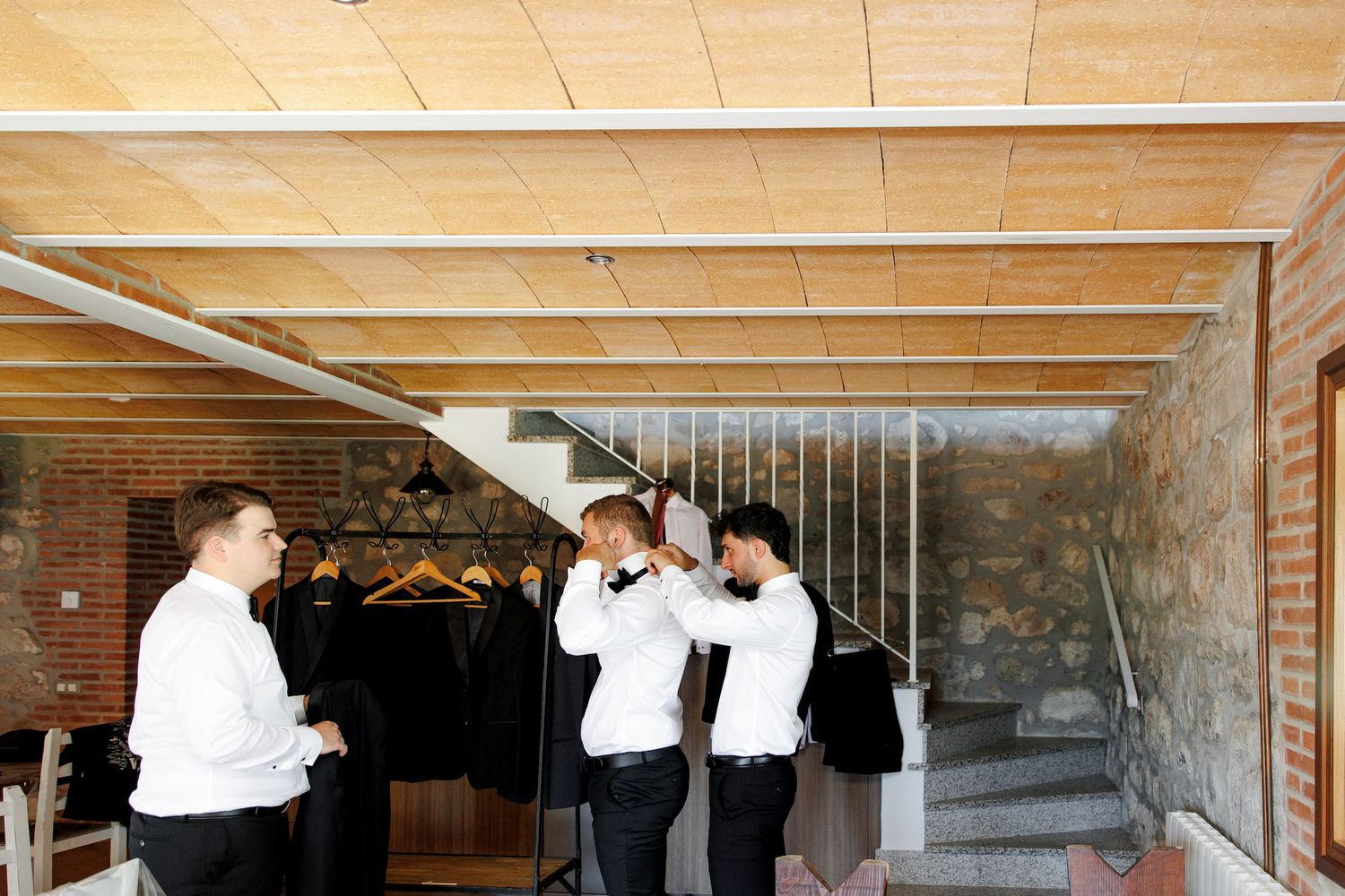 The groom and his best man share a candid moment as they get ready at the start of the wedding day.