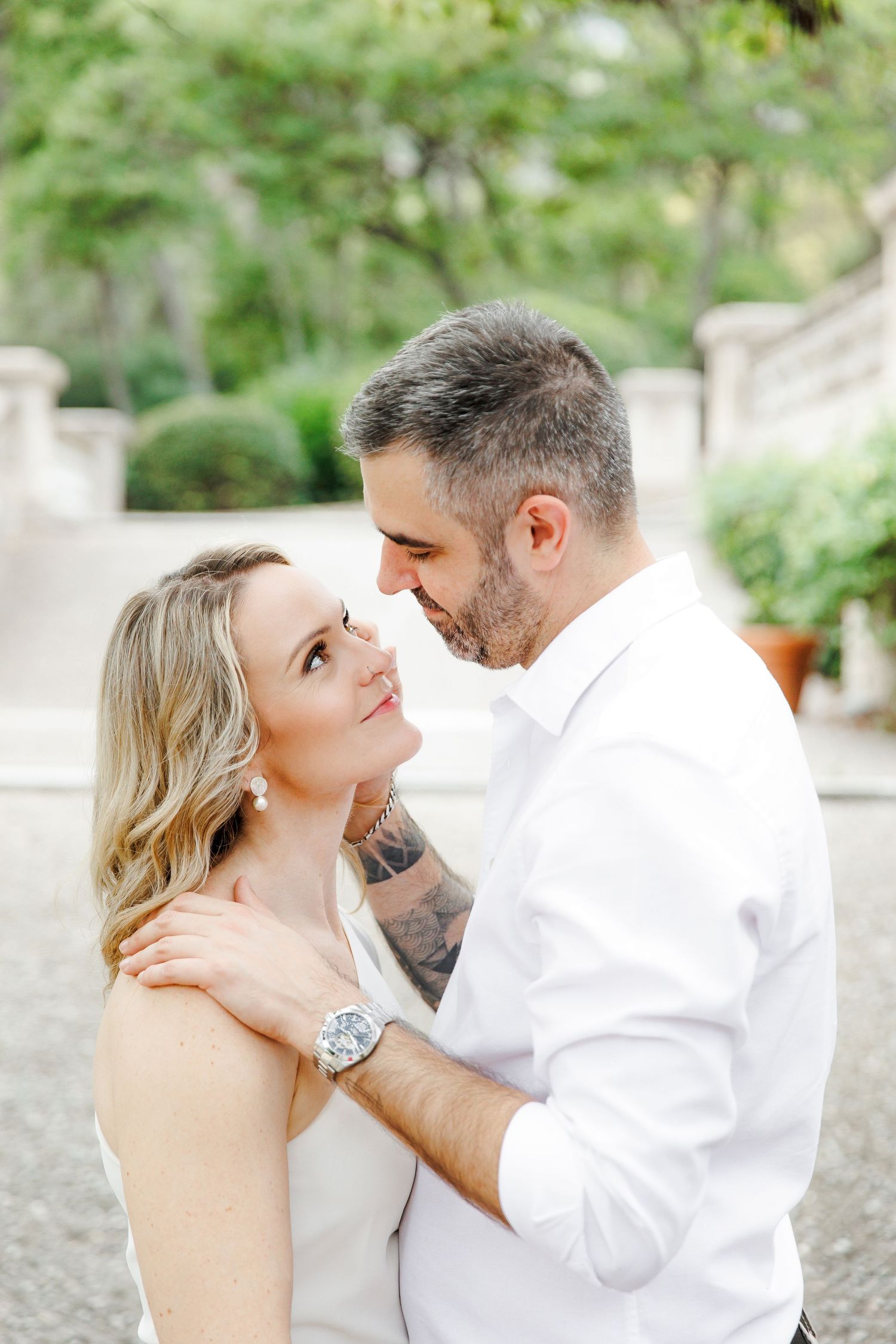 A couple shares a meaningful gaze during a romantic engagement shoot in Barcelona.