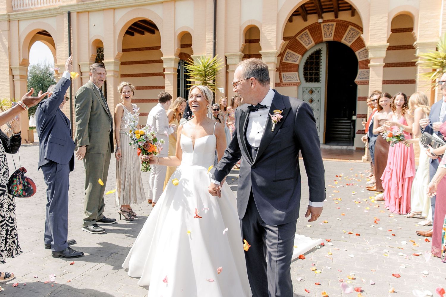Happy couple after the wedding ceremony, surrounded by their guests, Gran Villa Rosa wedding