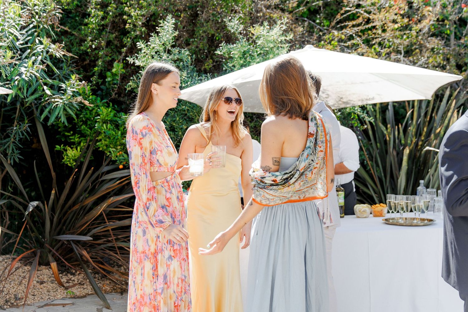 Documentary wedding moment of guests laughing at the cocktail hour