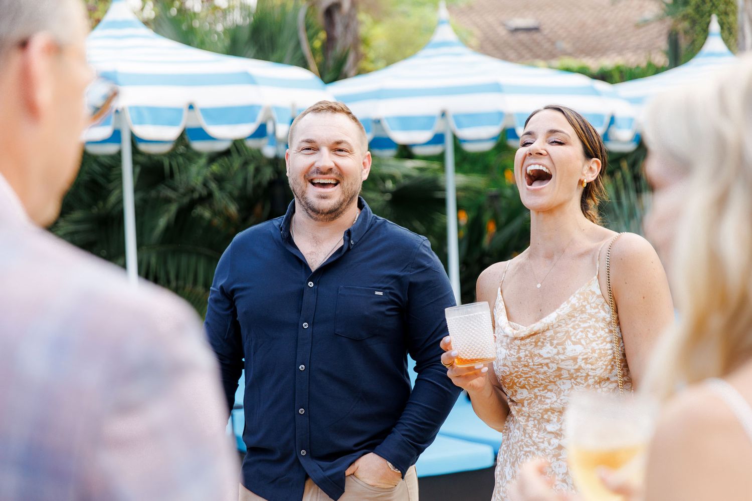 Guests sharing laughter during rehearsal dinner at Gran Villa Rosa, Barcelona