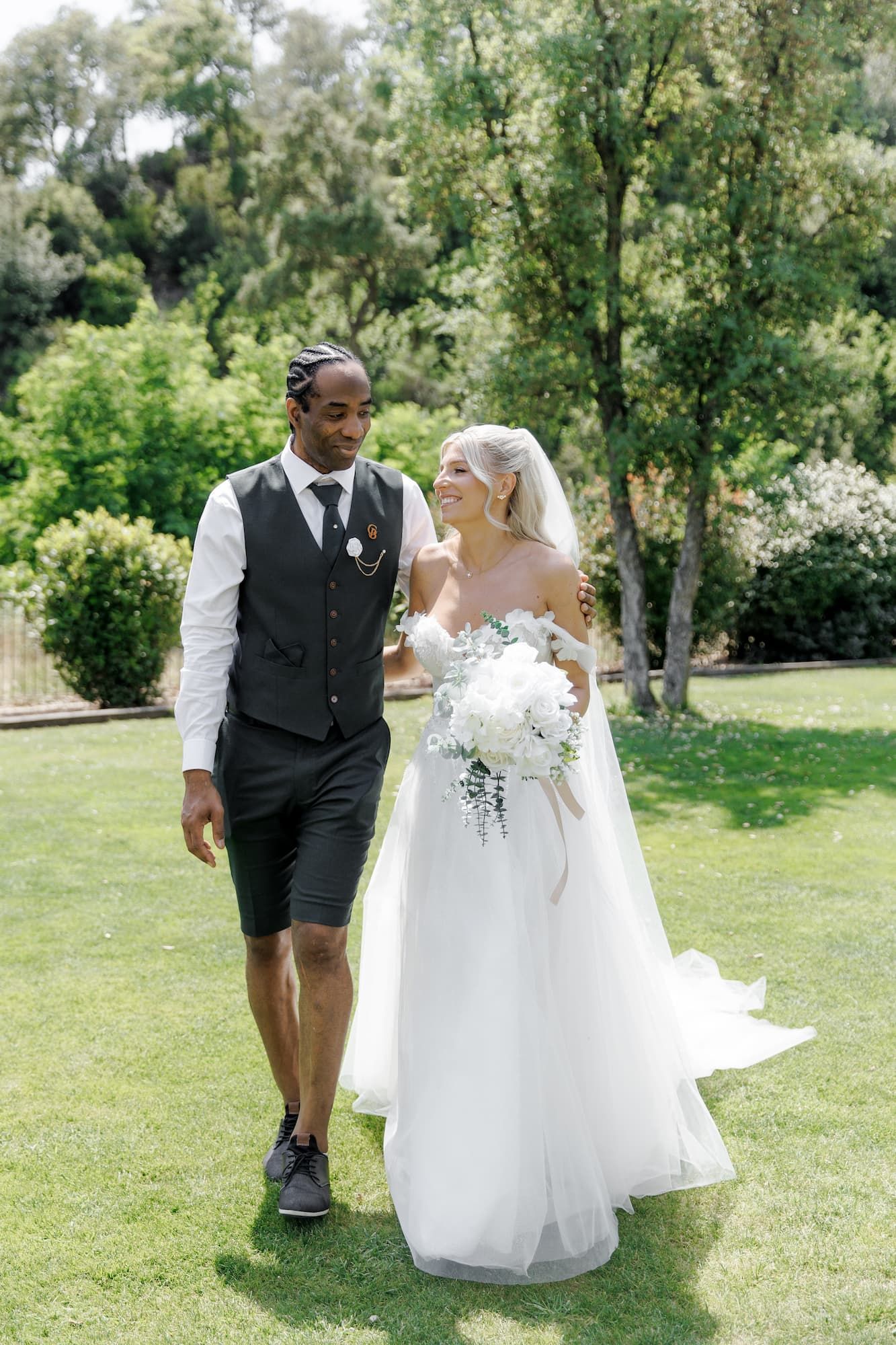 A couple walking outdoors on their wedding day in a Barcelona wedding venue