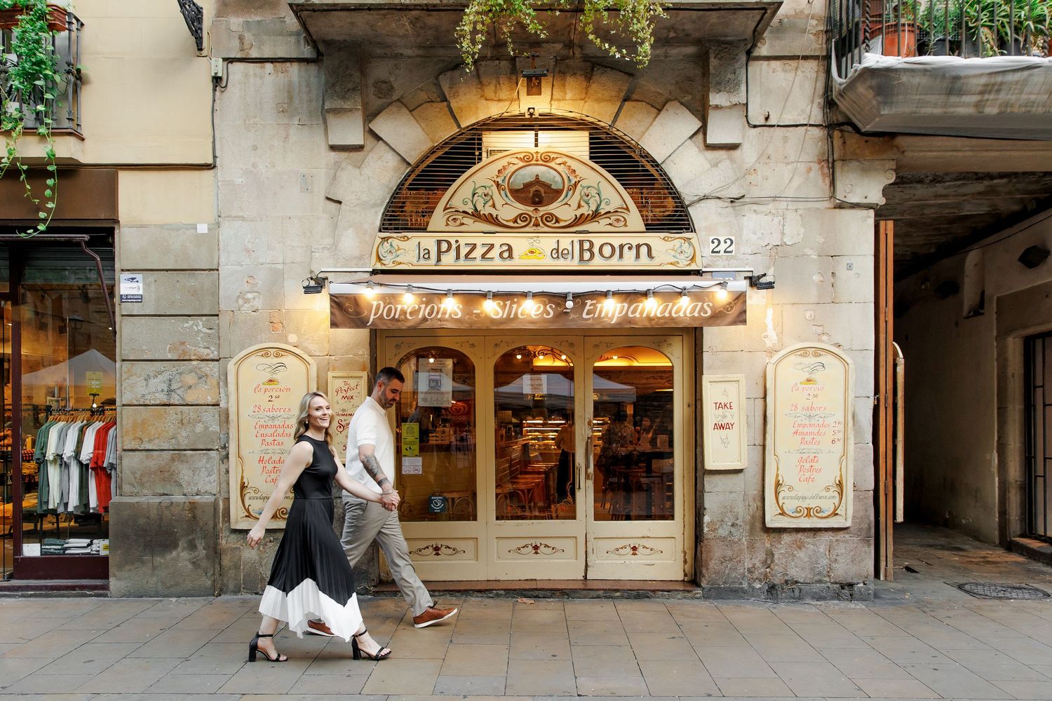 An engaged couple walks in the streets of Barcelona