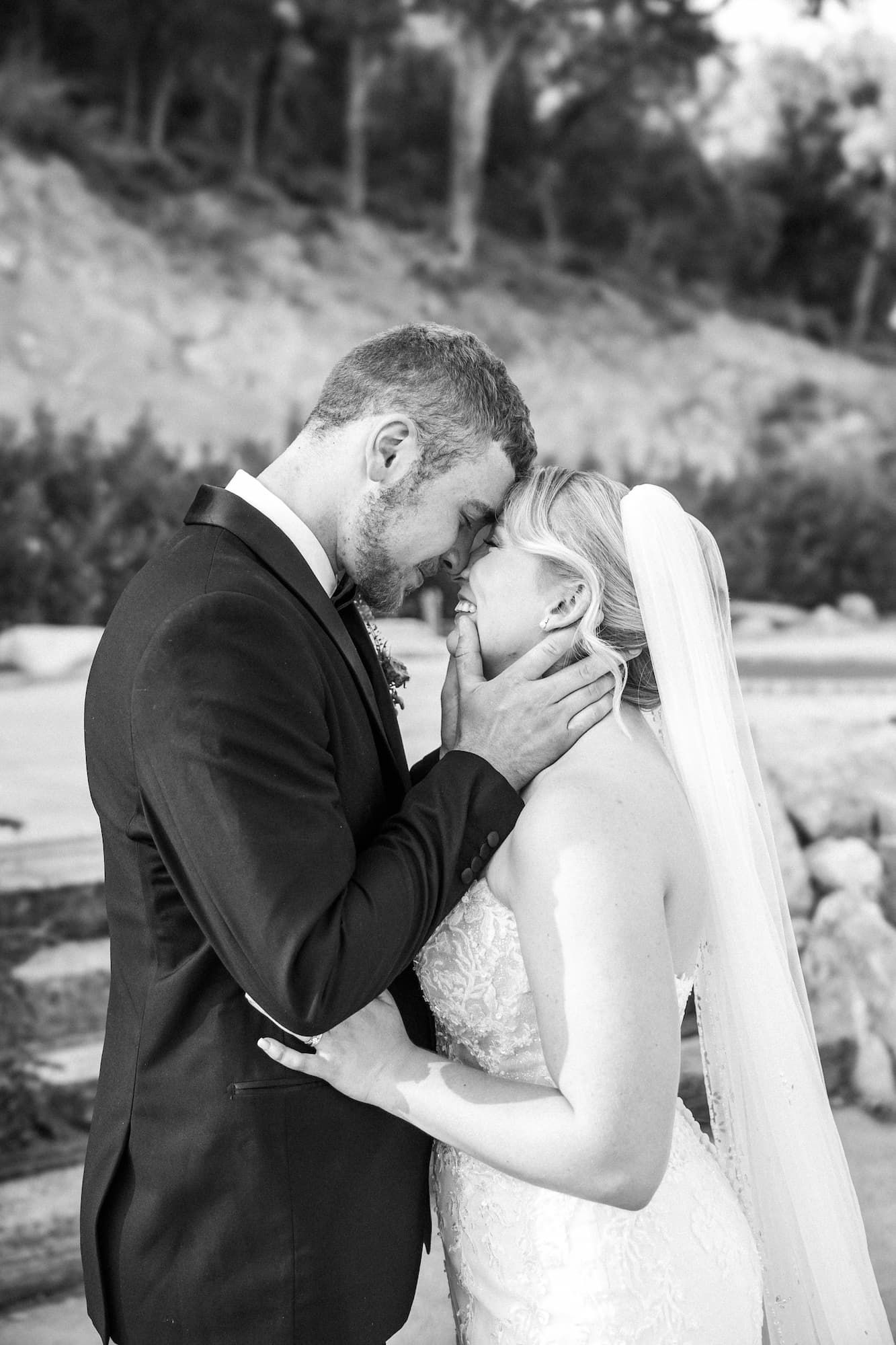A black and white photo showing a romantic kiss between newlyweds at their wedding ceremony in Barcelona